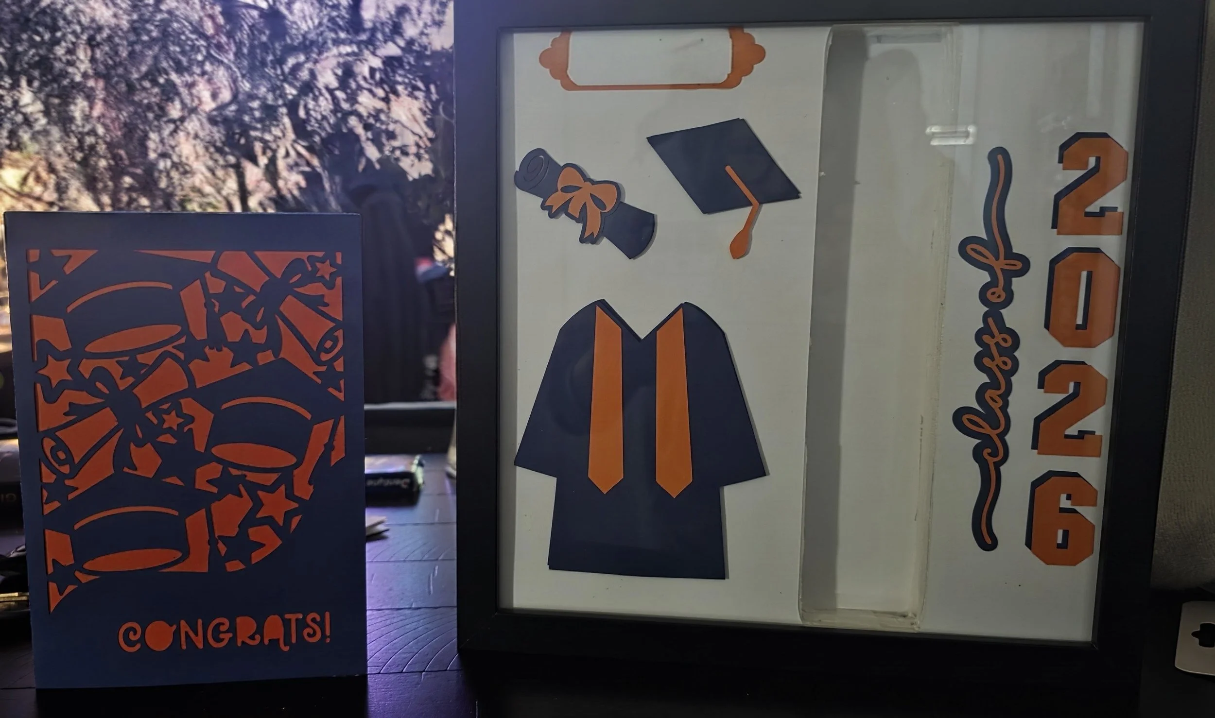 Celebration display with congratulatory cards and decorations including confetti, balloons, and a banner reading "Congrats!" in blue, orange, and black colors.