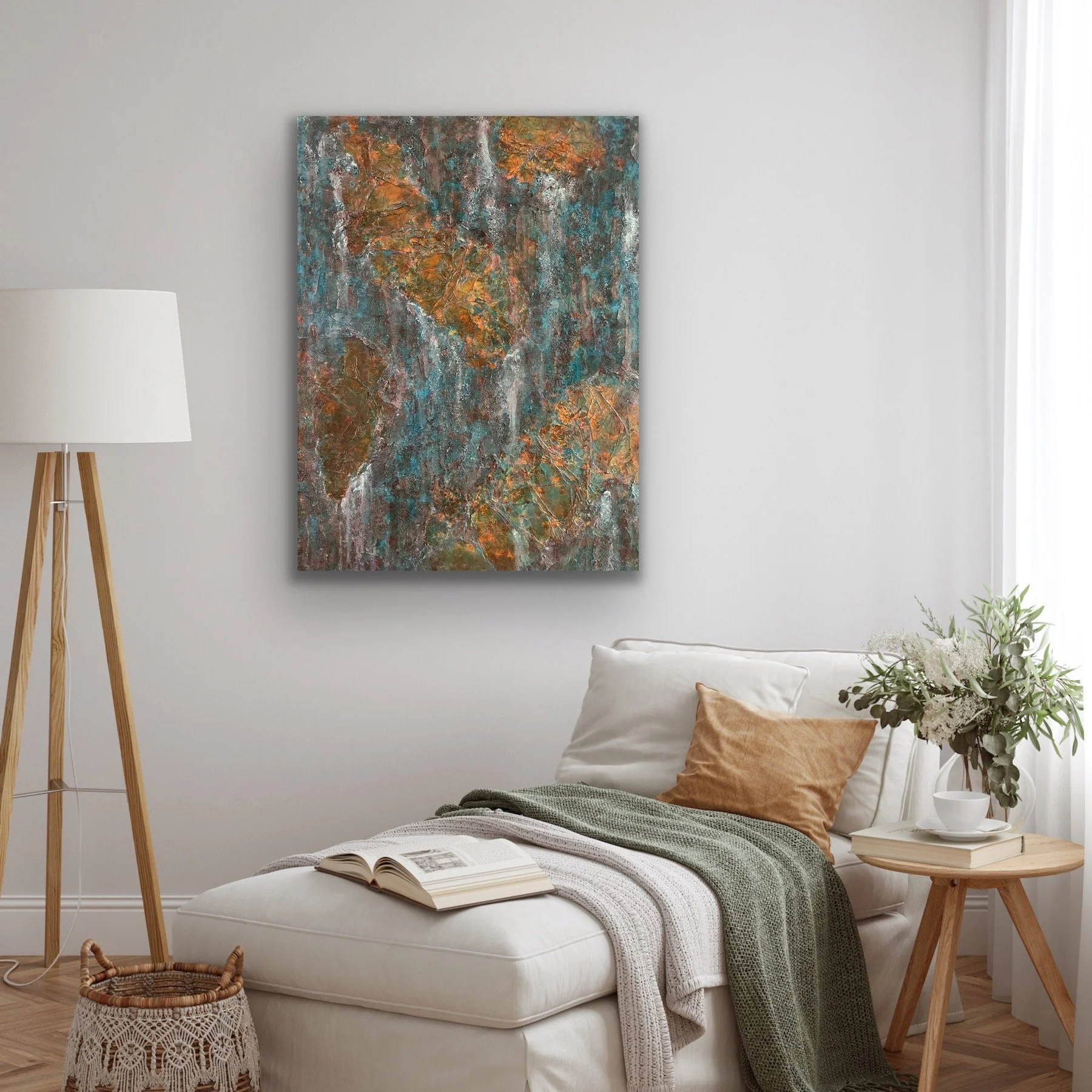 A cozy livingroom corner with a lounge sofa, decorative pillows, a throw blanket, open book, small side table, potted plant, wall art, and a floor lamp in a minimalist style.