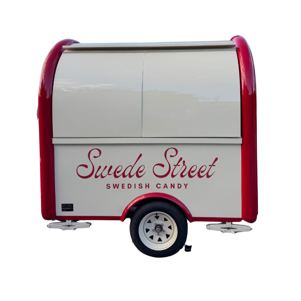 A white and red mobile food trailer with the words 'Swede Street Swedish Candy' written on the side.