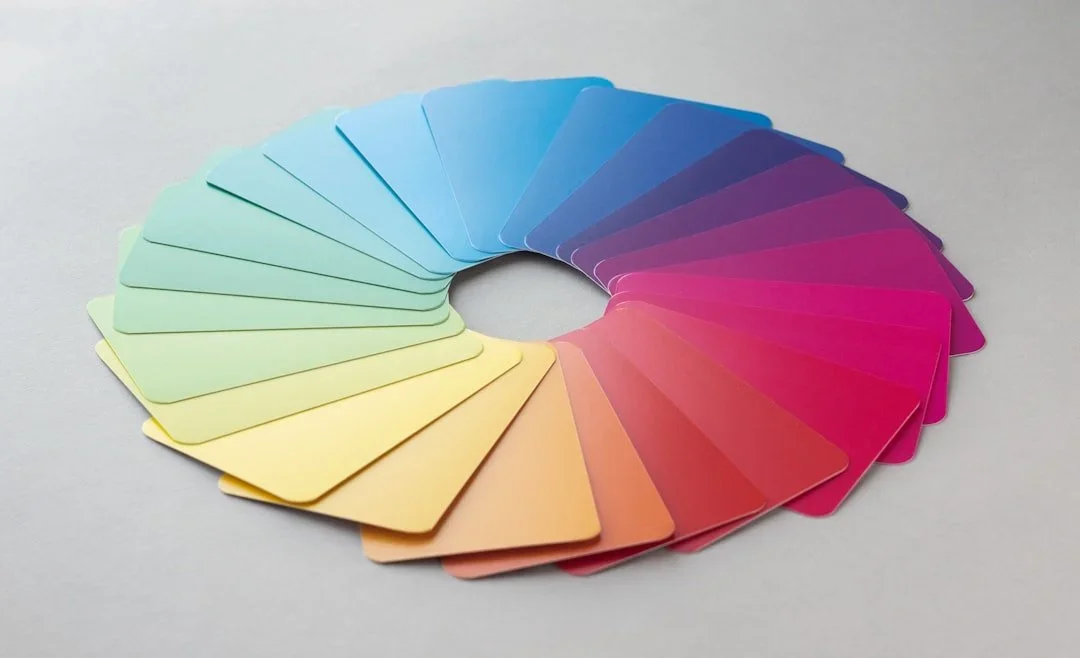 Color palette of rectangular color samples arranged in a semi-circle, transitioning from green to yellow, orange, pink, purple, and blue.