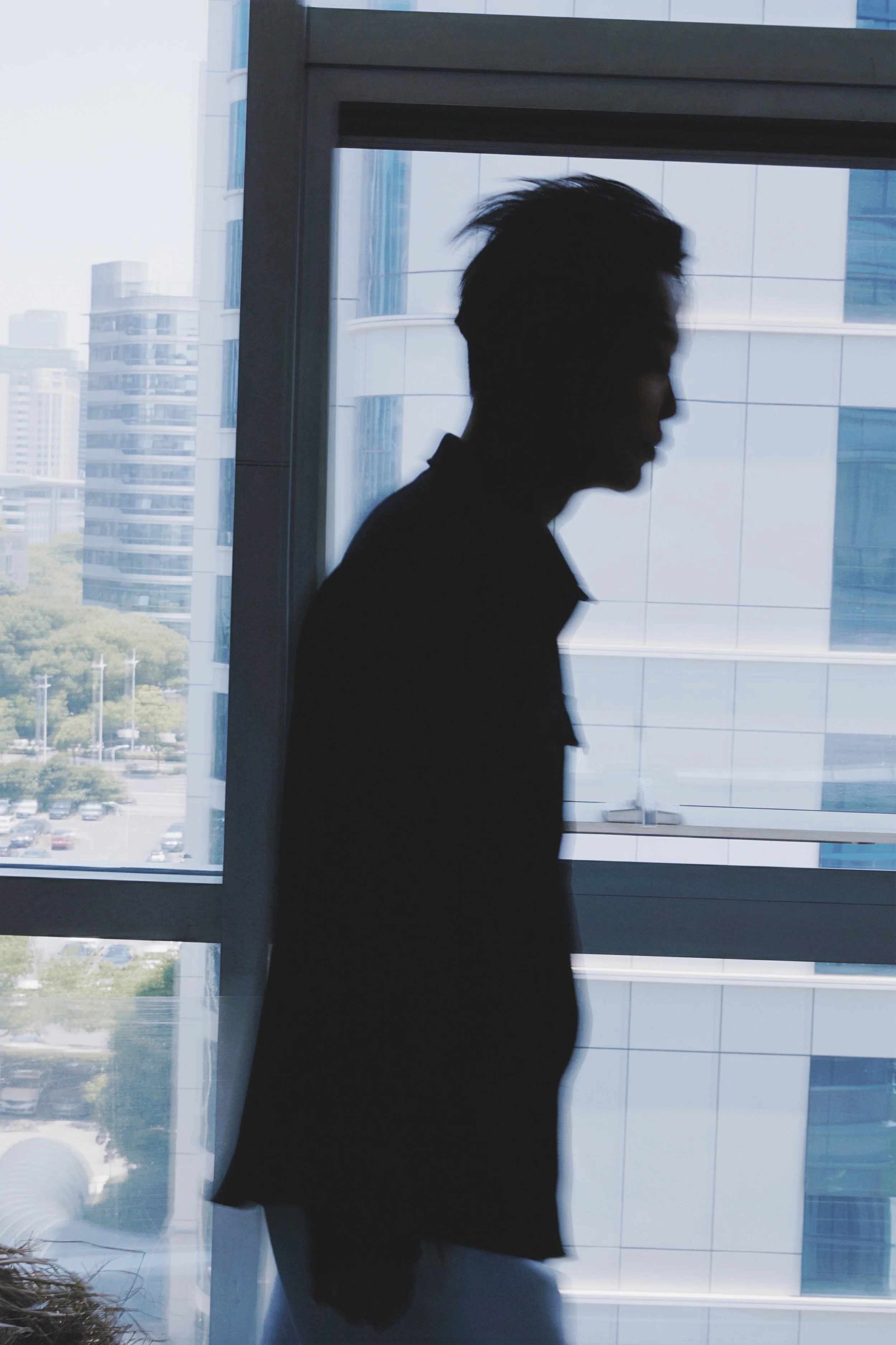 Profile portrait of the artist in a contemporary urban setting.