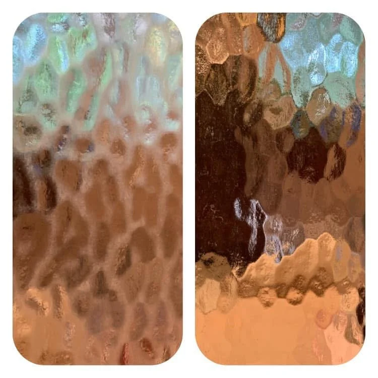 Abstract close-up of iridescent textured glass panels in pastel blue, green, brown, and copper tones