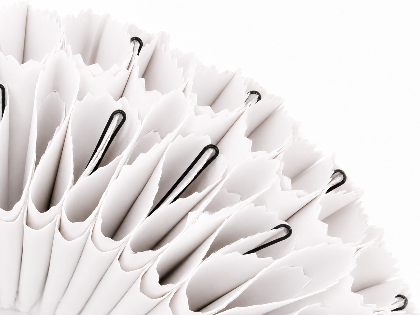 Close-up of a white NJITS lampshade made from folded reclaimed advertising banner material.