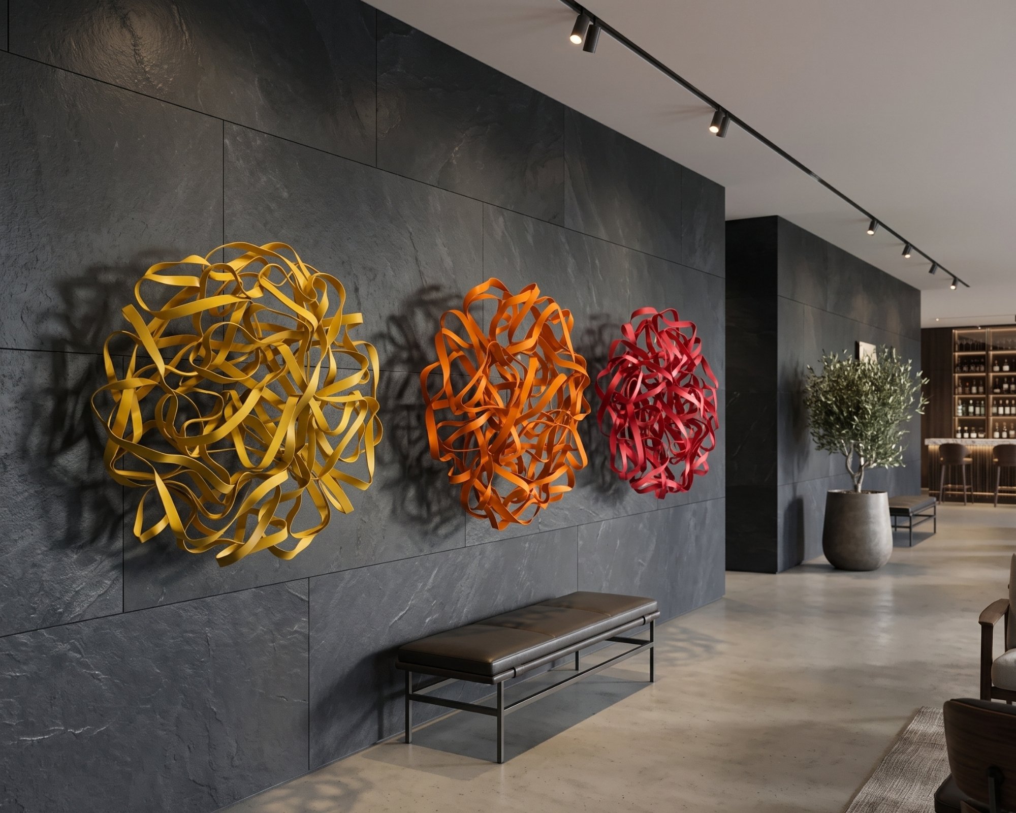 vibrant-round-metal-decor-triptych-black-stone-lobby.jpg
