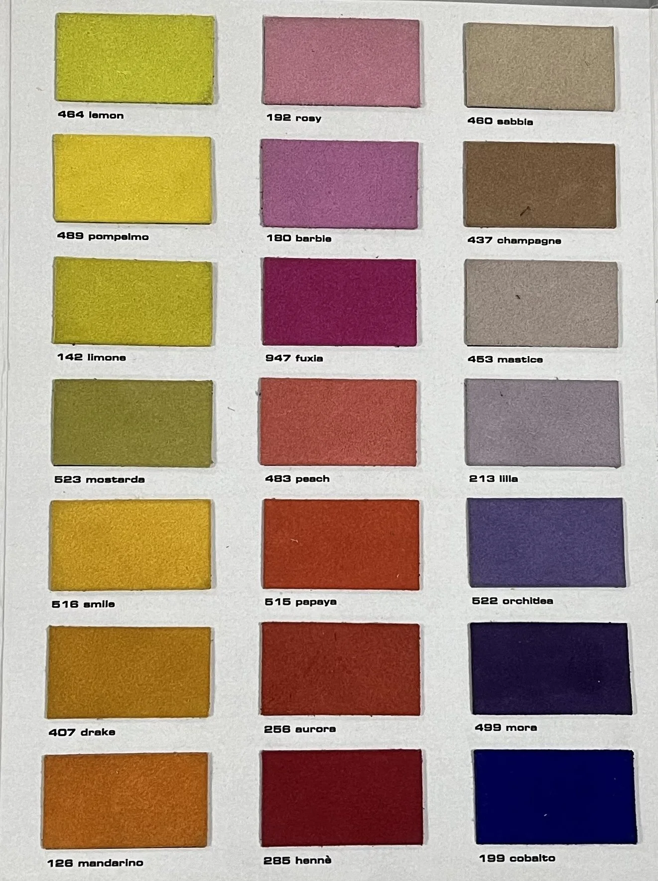 Color chart with rectangular color swatches arranged in rows. Each swatch is labeled with a number and color name, including shades of yellow, pink, brown, purple, orange, red, and blue.