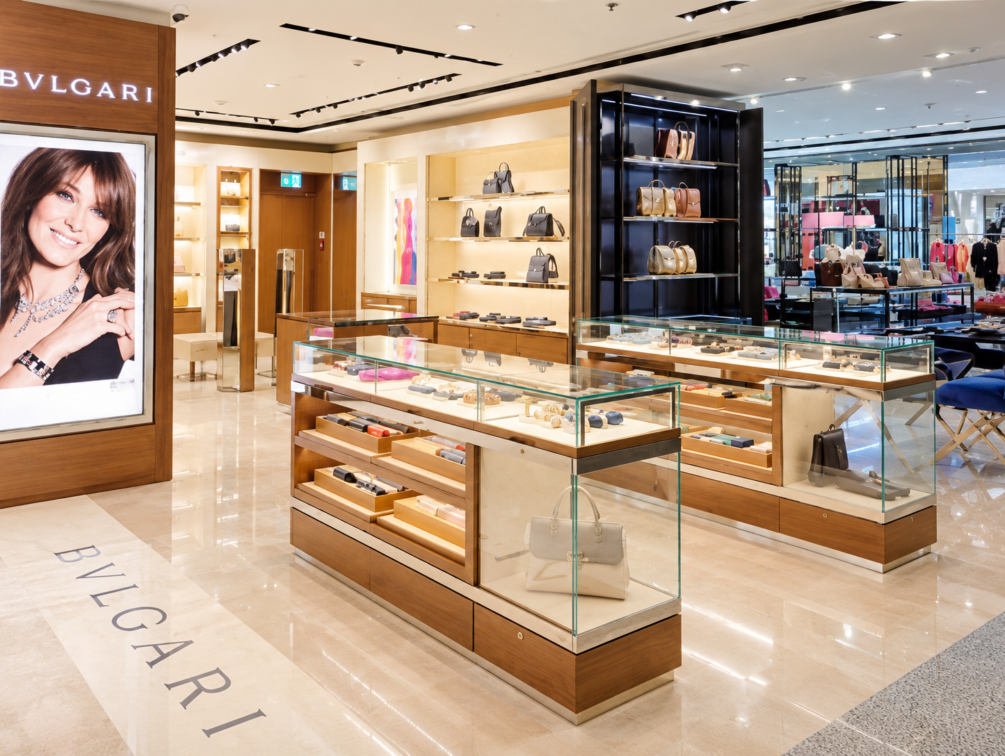 Inside a luxury jewelry store with display cases containing watches and handbags, and shelves with luxury handbags on a well-lit, elegant interior.