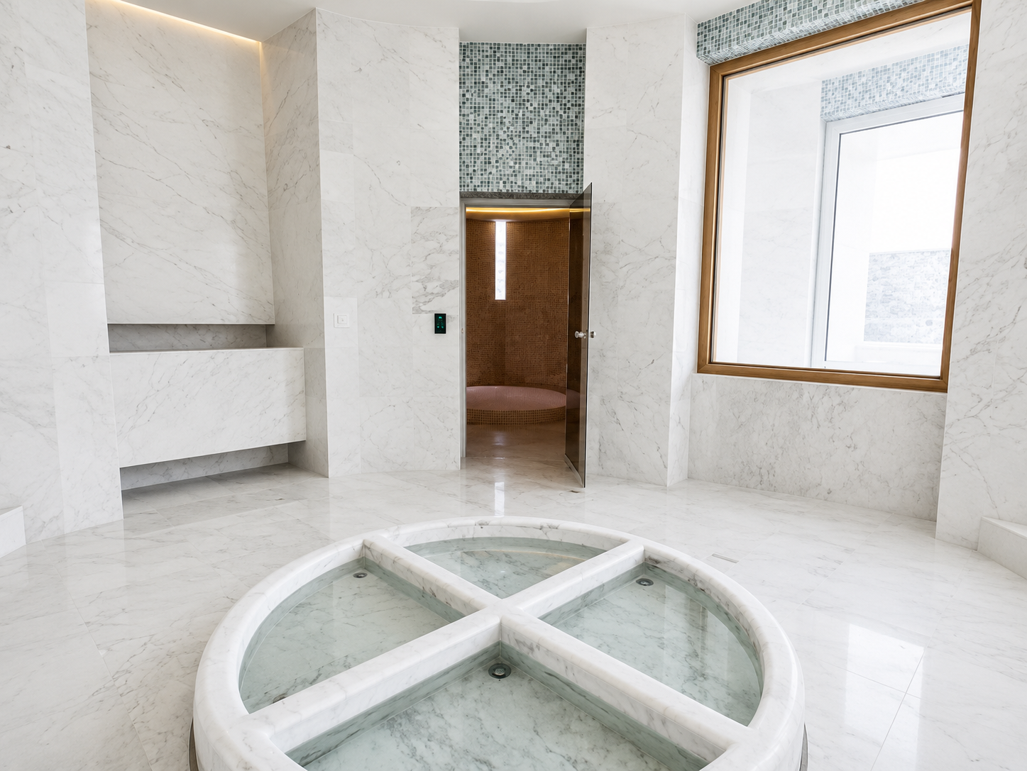 Modern marble sauna or spa room with a round glass-covered hot tub in the center, a door leading to a shower area, and large windows with wooden frames allowing natural light.