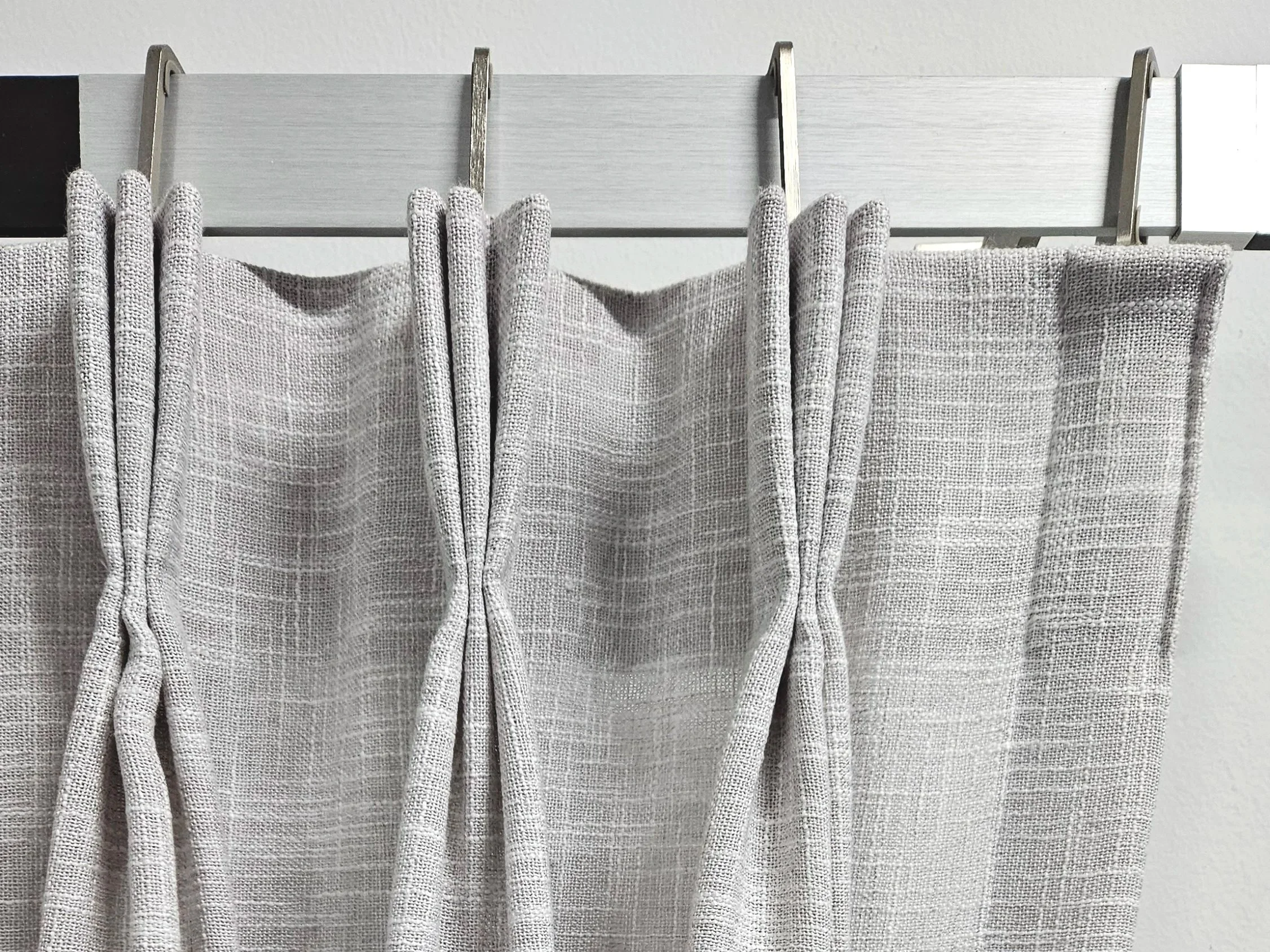 Triple pinch pleat in a decorative track