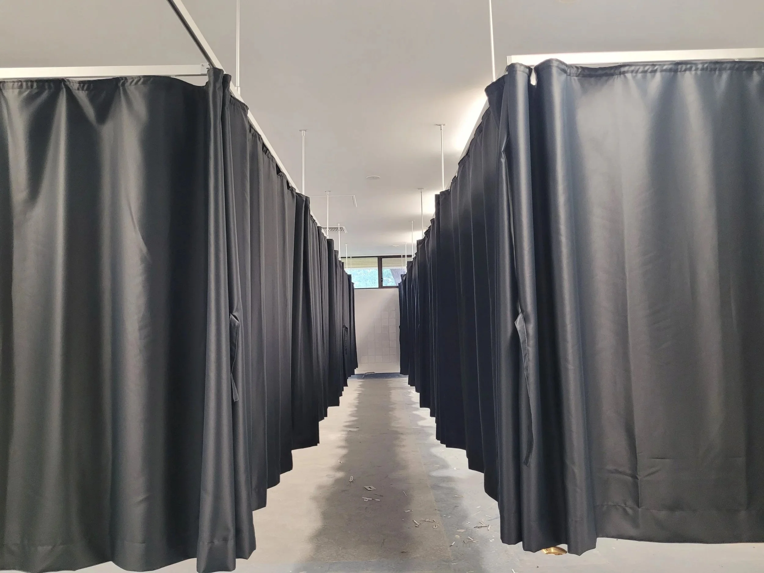 Oversize divider curtains on suspended tracks
