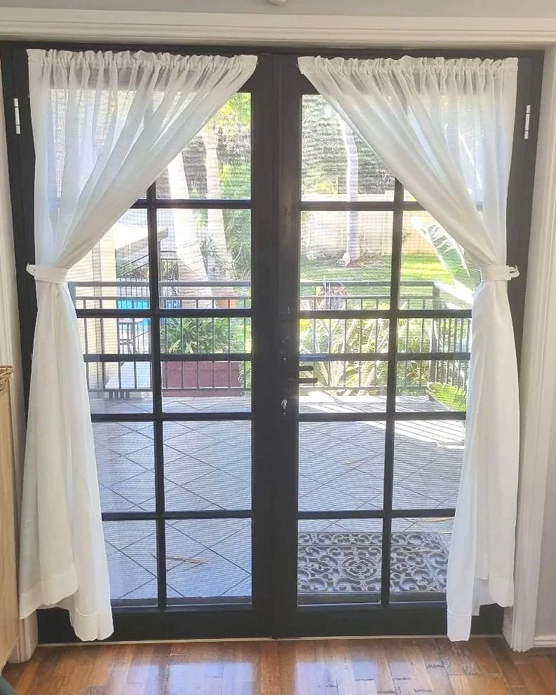 Rod and Pocket curtains on French door, swagged back
