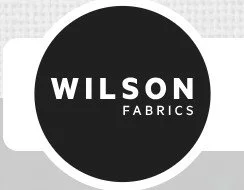 Wilson Fabrics logo in a black circle with white text