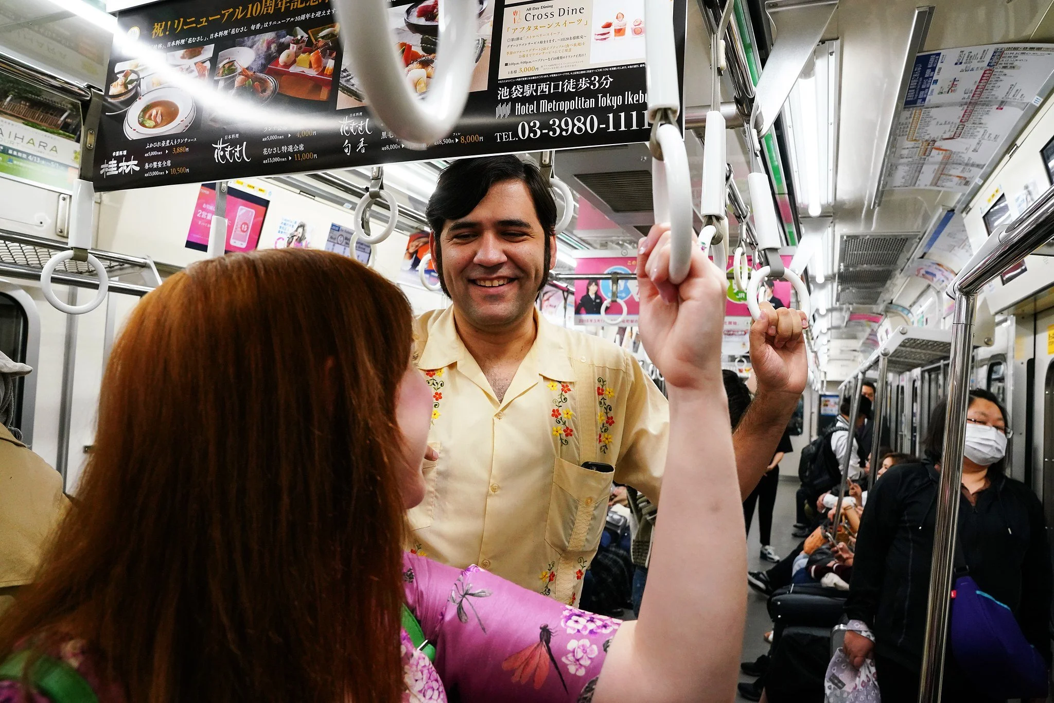 Couple laughing together on a Tokyo train