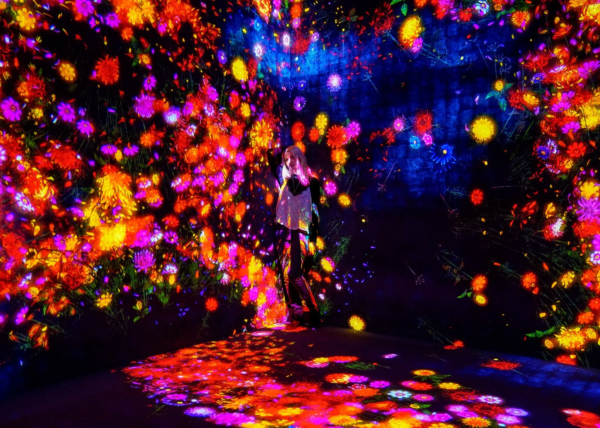 Woman in the digital flower room at teamLab Borderless, Tokyo