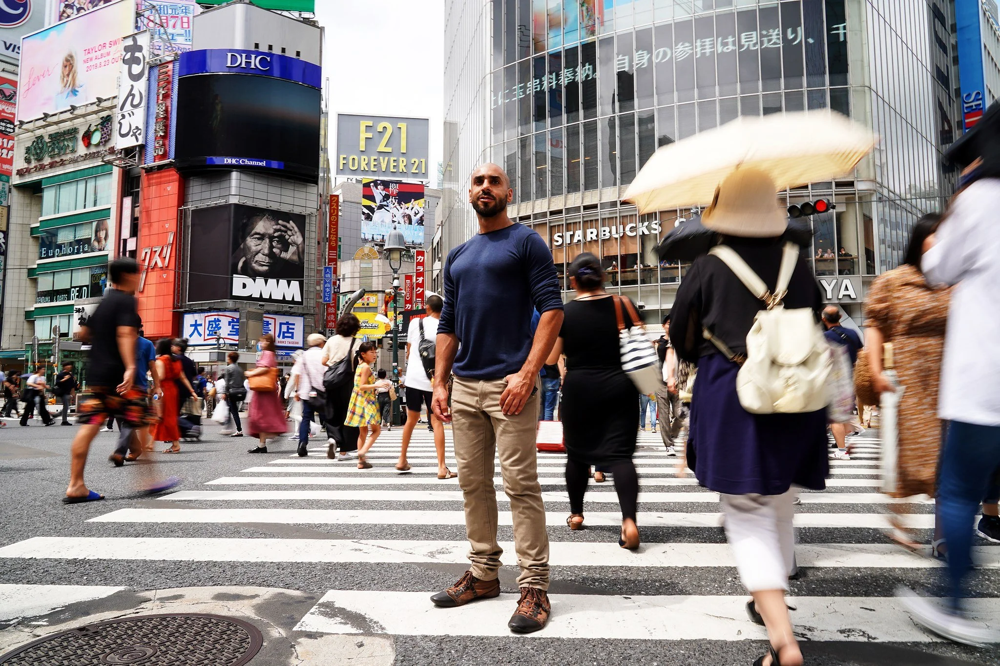 Man standing still in the Shibuya Scramble Crossing crowd