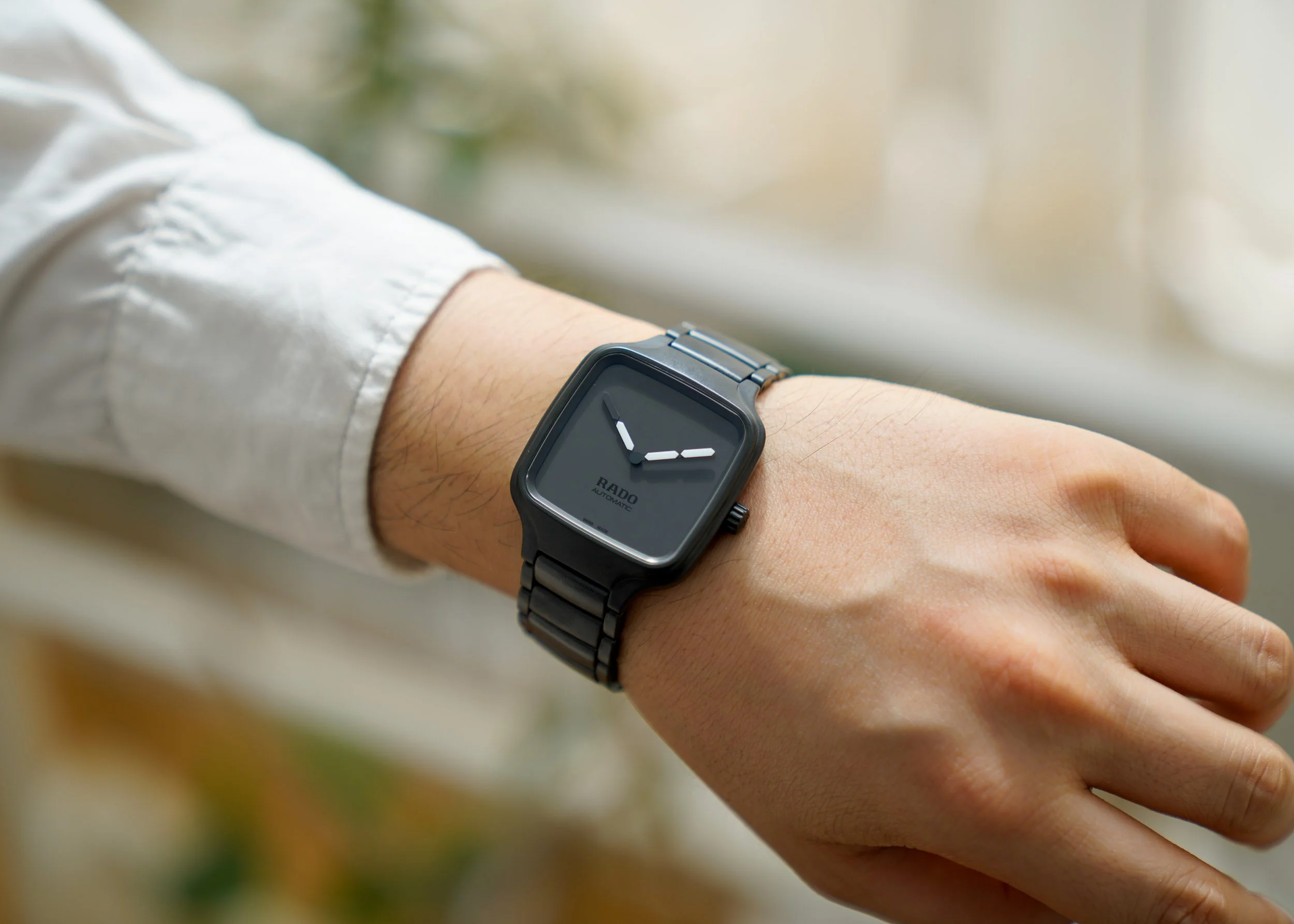Close-up of a Rado True Square watch worn on the wrist