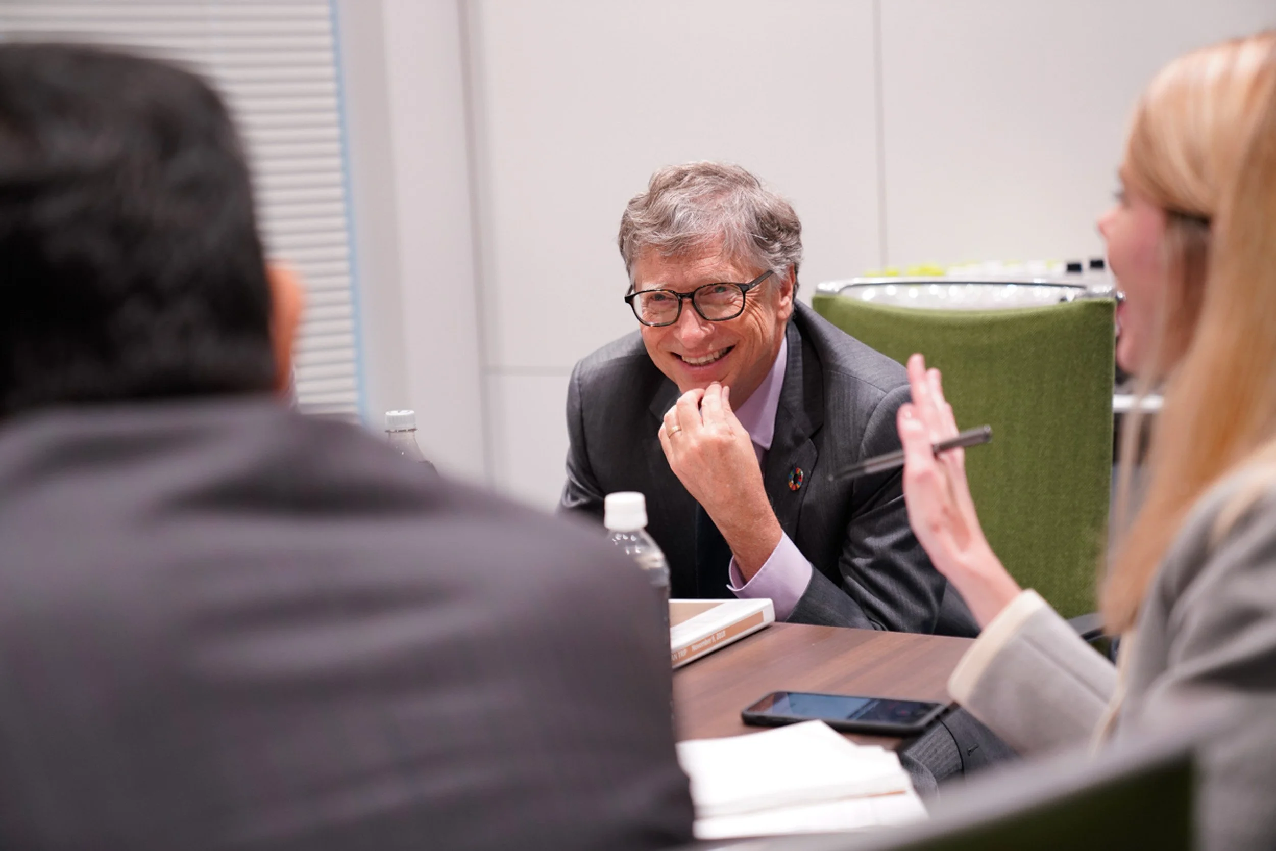 Bill Gates smiling during a business meeting in Tokyo