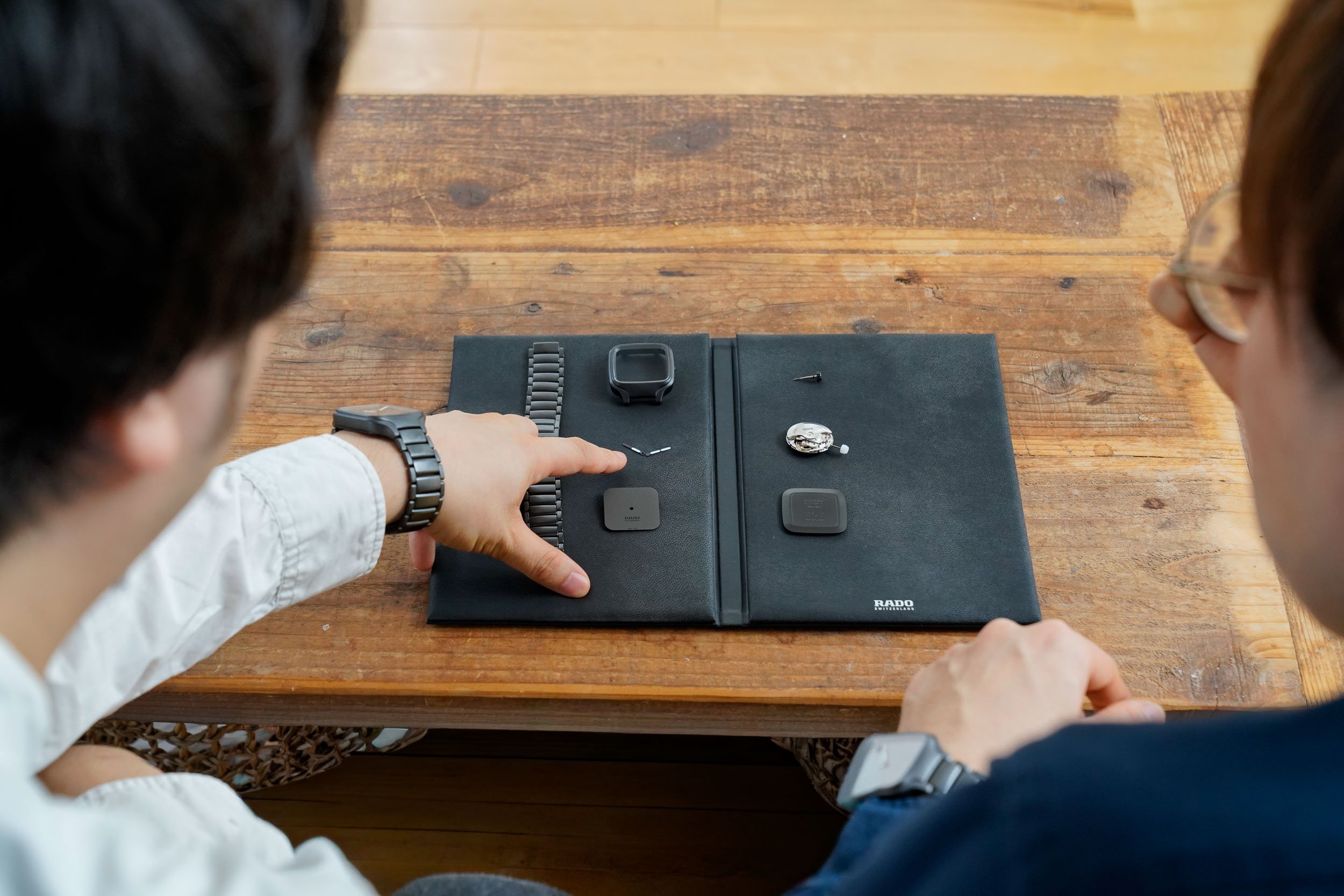 Overhead shot of Rado True Square watch components and product development sketches