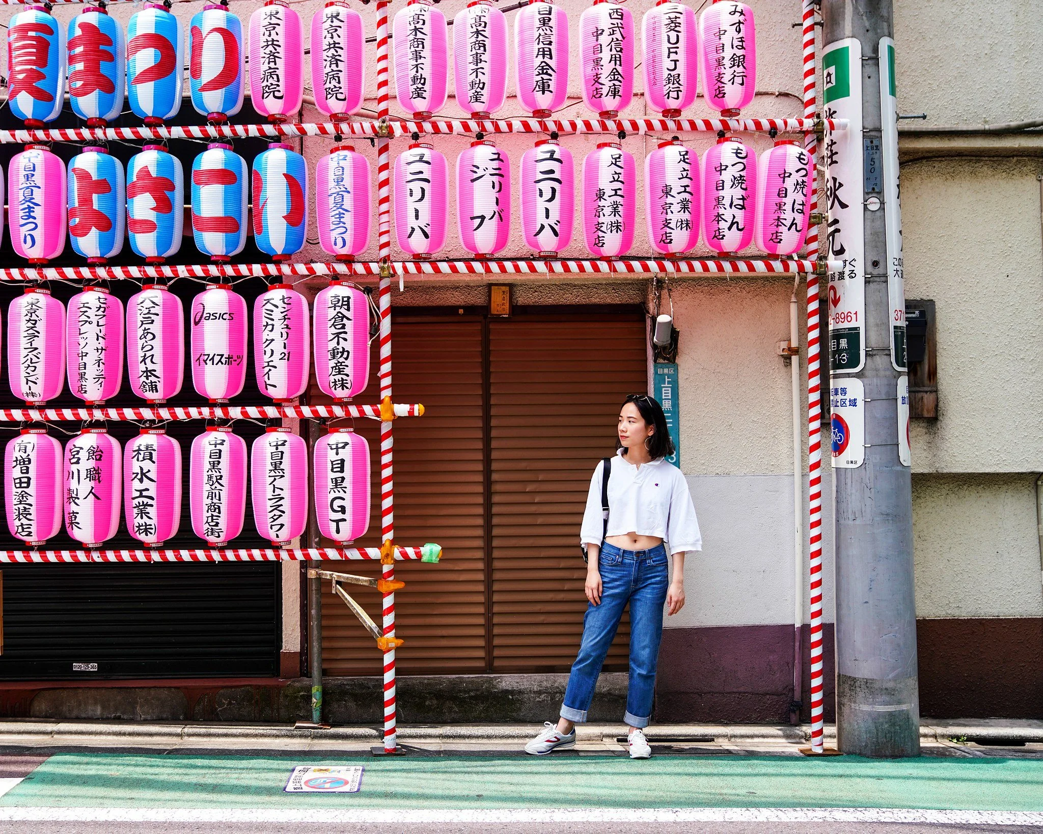 Woman beside pink summer-festival lanterns in Nakameguro