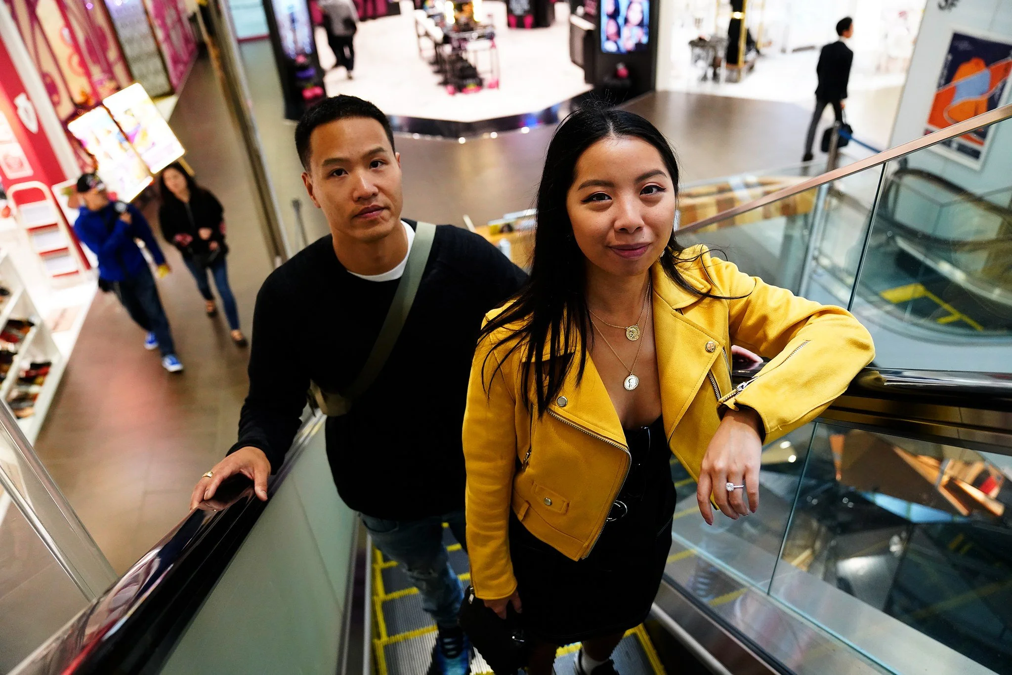Couple riding an escalator in a Tokyo shopping mall