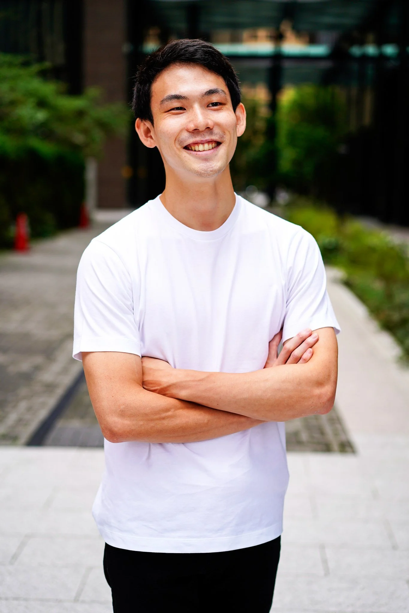 Smiling man with arms crossed in Marunouchi, Tokyo