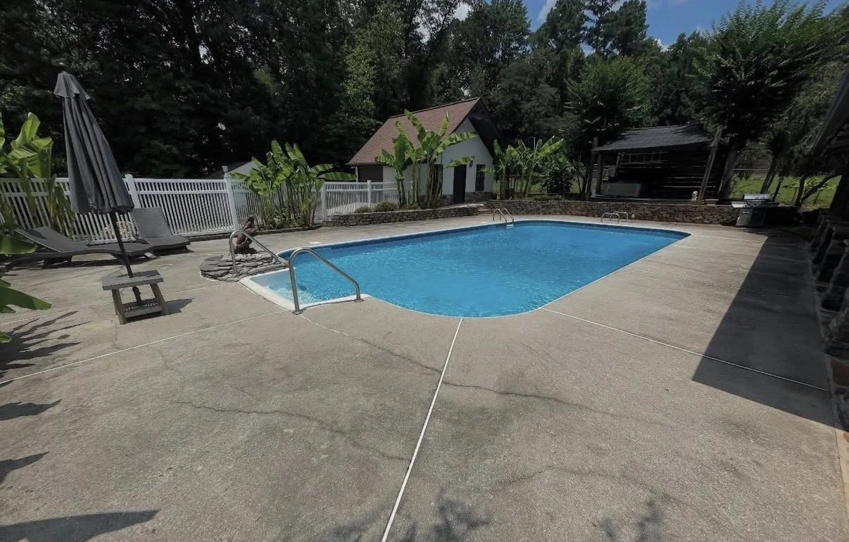 Refresh your concrete pool deck with a quick pressure wash from Hearn Exterior Services.  Night and day difference.