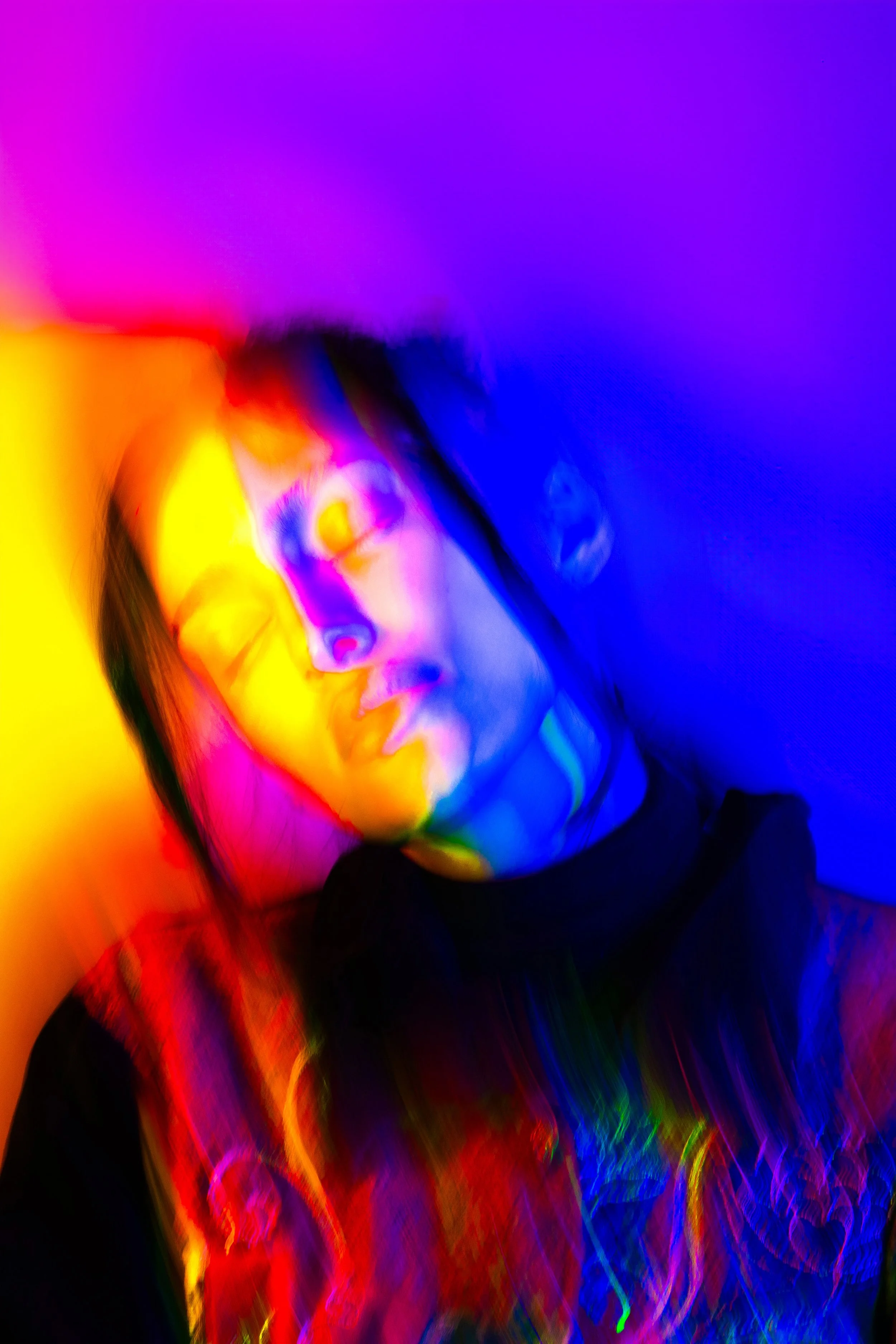 A colorful, abstract digital art portrait of a woman's face with vibrant, blurred rainbow lights.