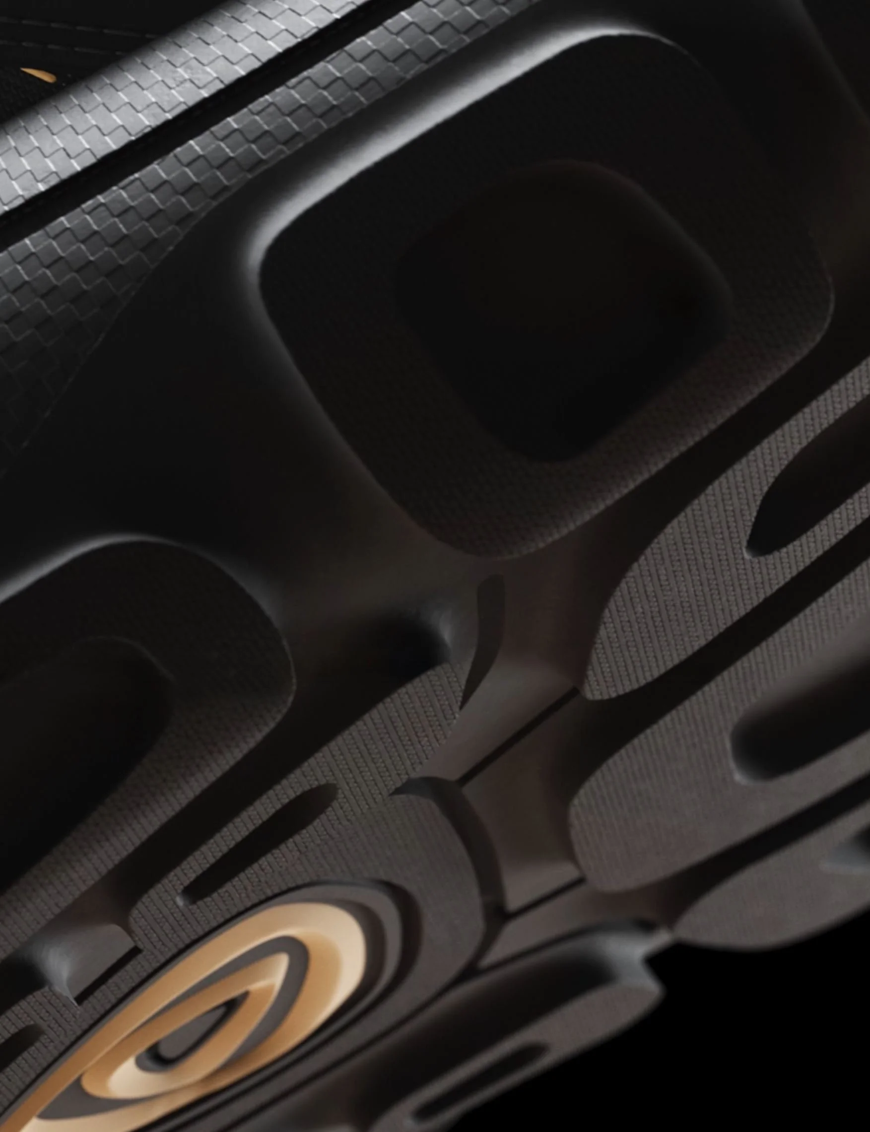 Close-up of a black speaker with a cone-shaped grille pattern.