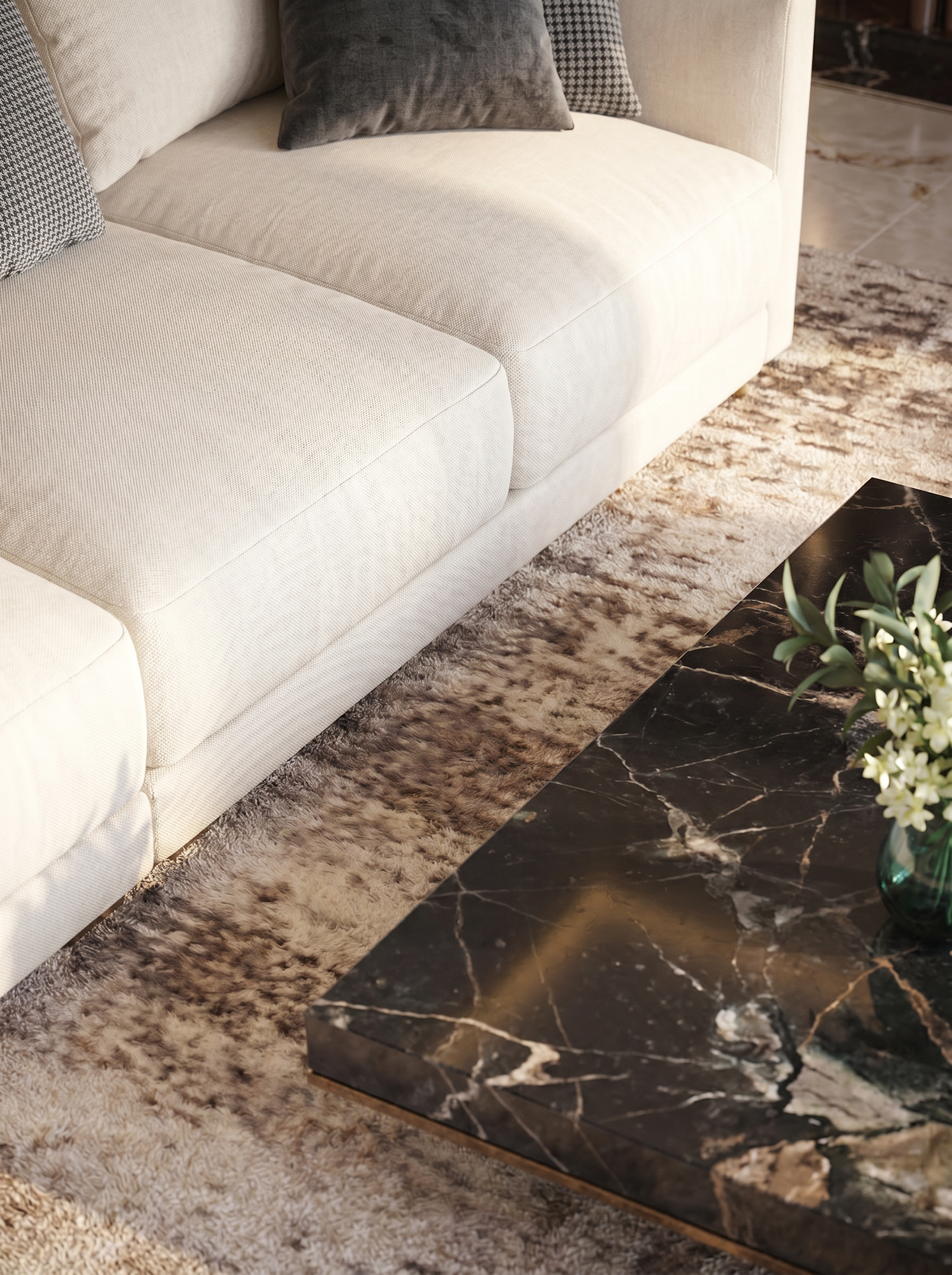 Living room with a beige sofa with textured fabric and decorative pillows, a shaggy rug, and a black marble coffee table with white and gold veining, with a green plant on top.