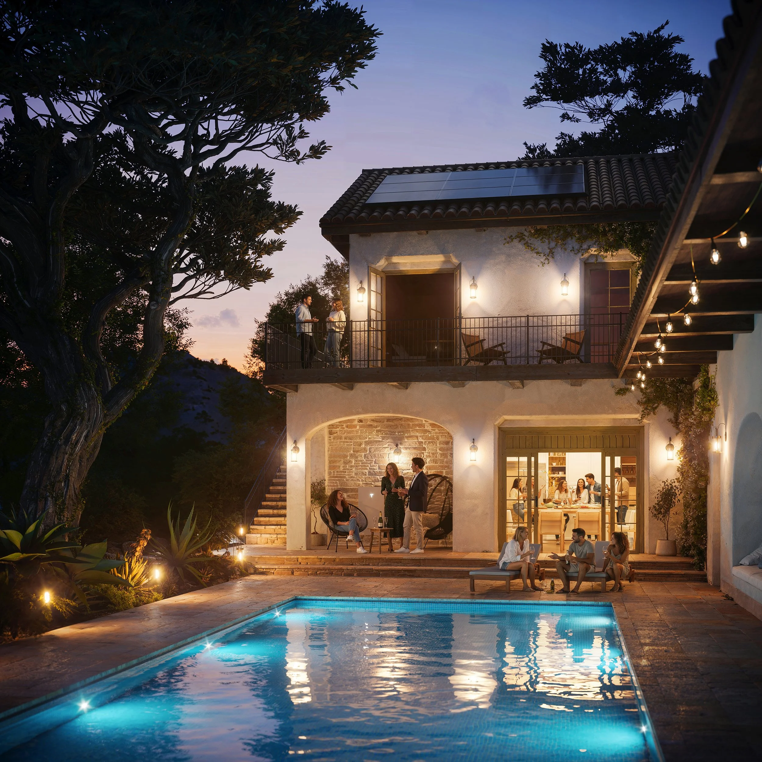 A backyard scene during the evening with a pool in the foreground, illuminated by underwater lights, and a two-story house with string lights and an outdoor patio where people are socializing, trees, and a sunset sky in the background.