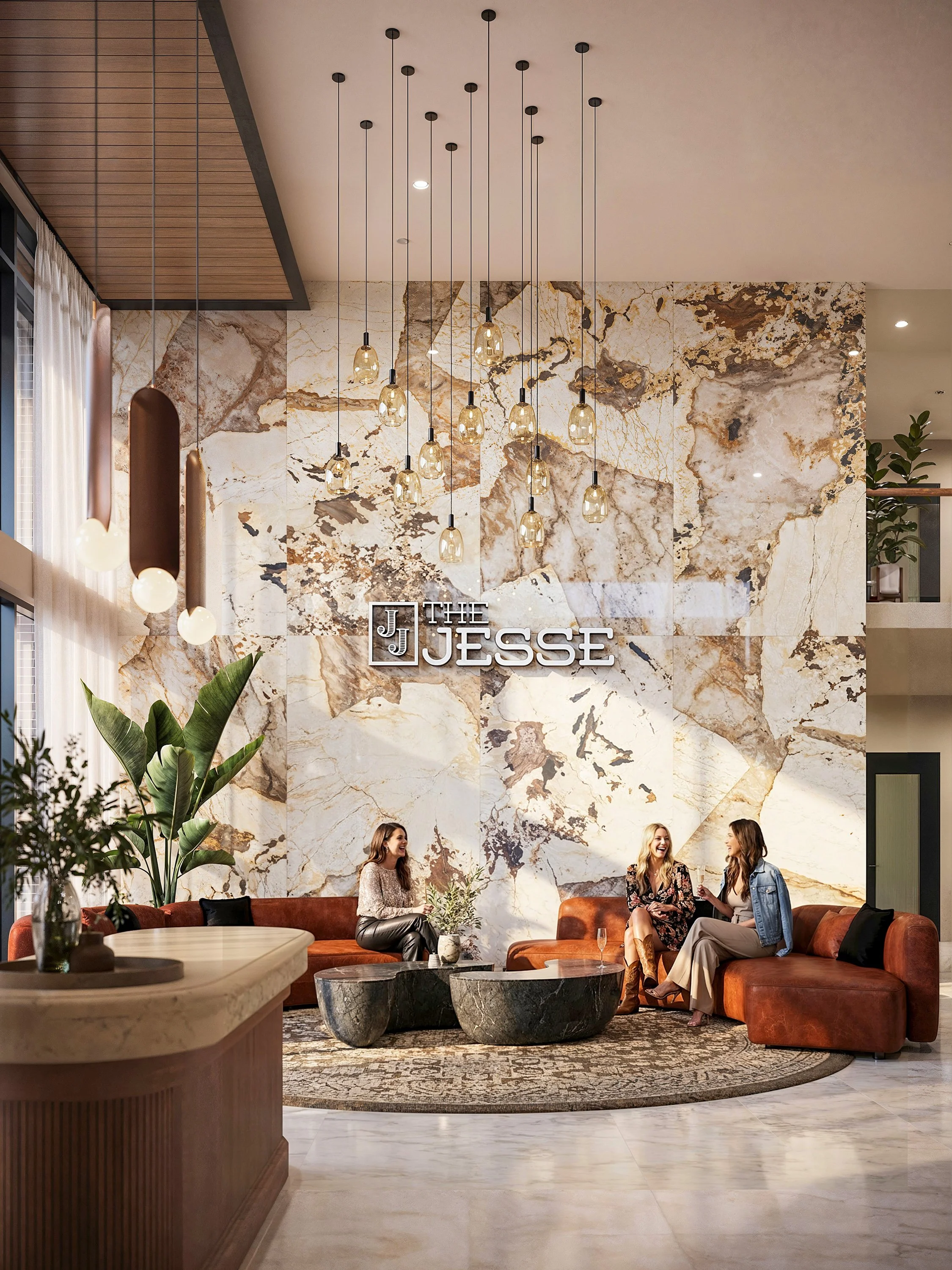 Interior of a stylish lounge or lobby area with a large marble wall, modern pendant lights, and people sitting on a curved leather sofa, engaged in conversation.