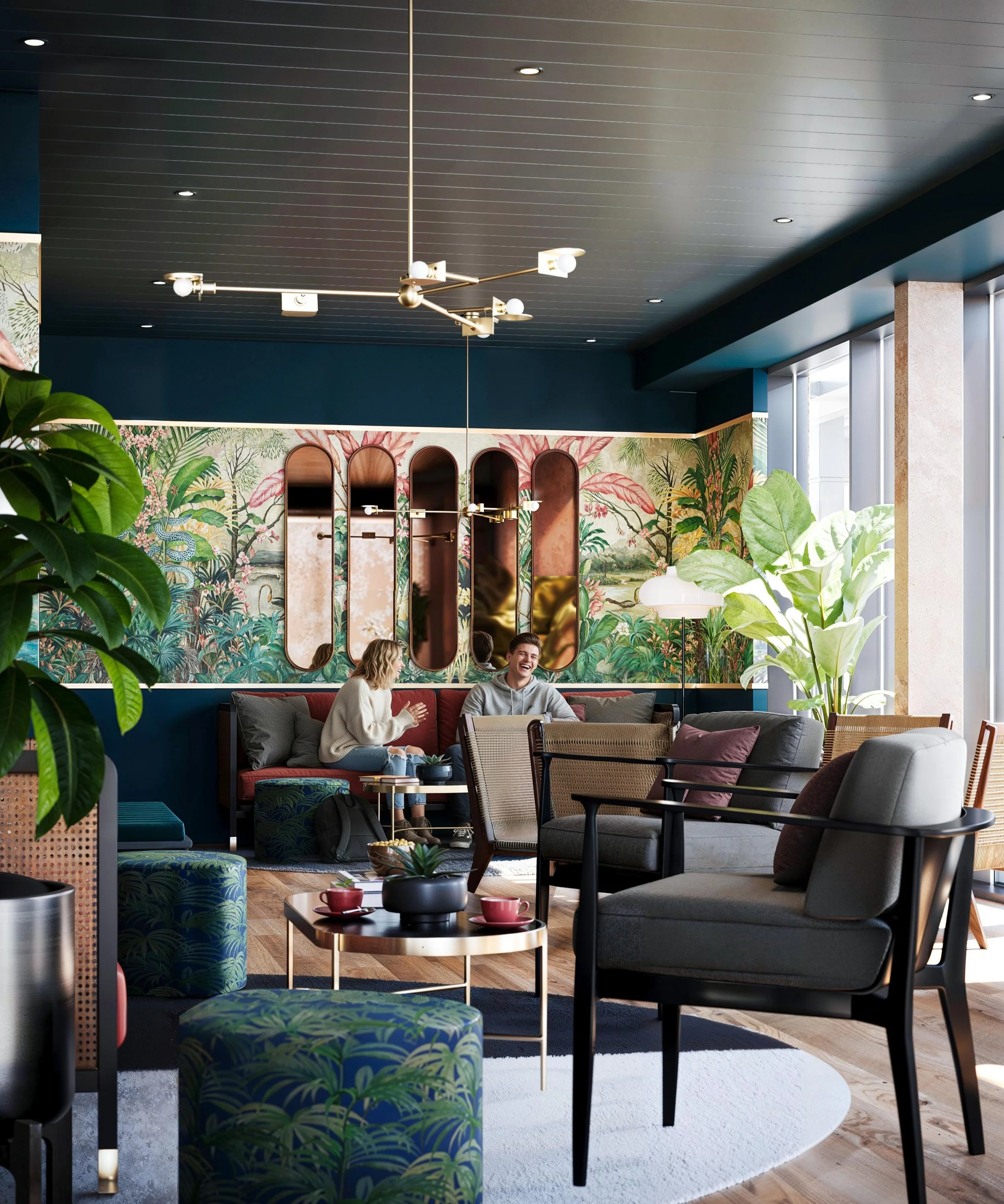 Modern hotel lobby with tropical wallpaper, large green plants, a dark gray sofa, and a small table with cups. There are multiple mirrors on the wall, and contemporary lighting fixtures hang from the ceiling.