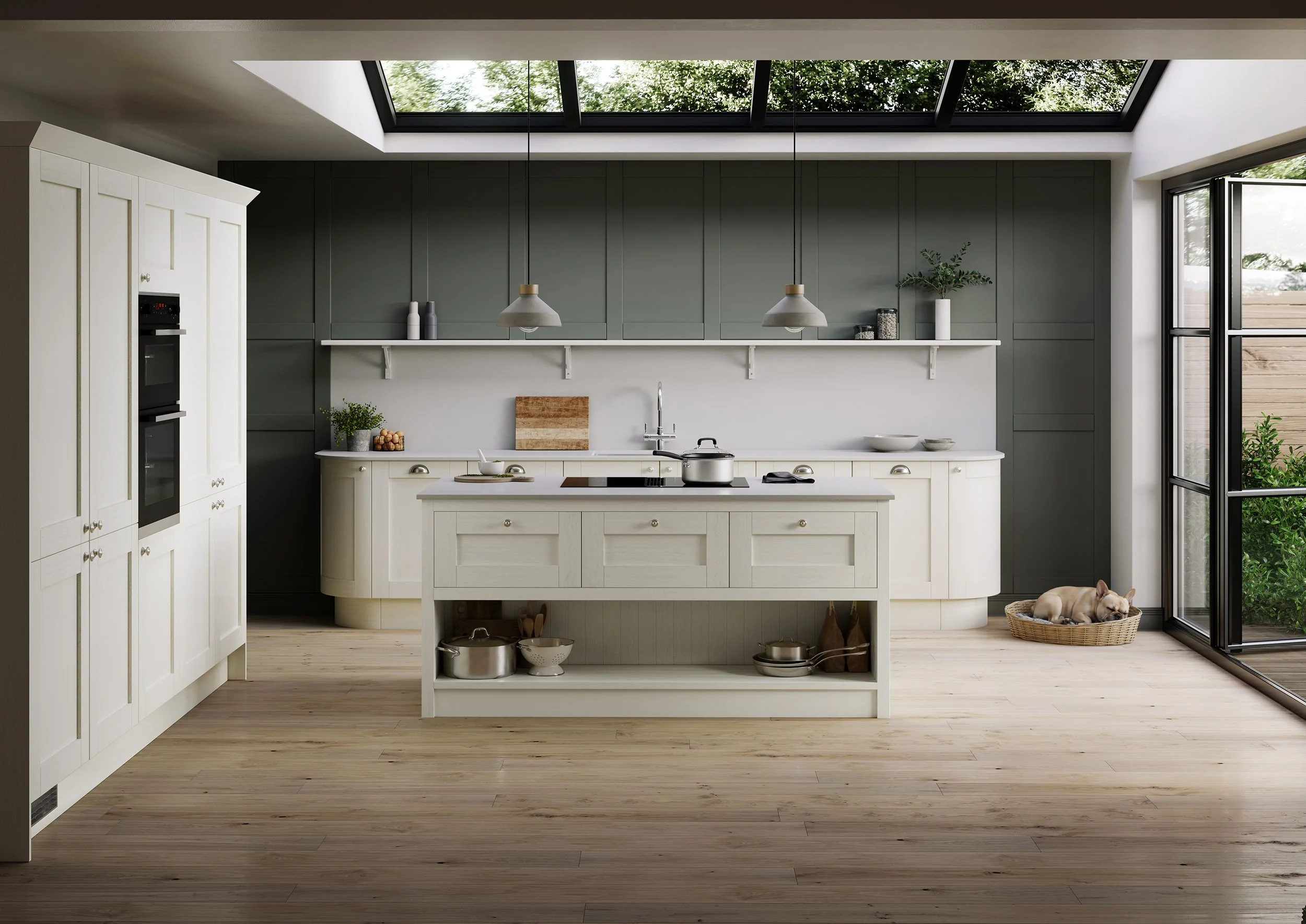 Modern kitchen interior with white cabinetry, a central island, green paneled walls, large skylight, and an open door showing outdoor greenery. There is a dog resting in a basket on the floor.