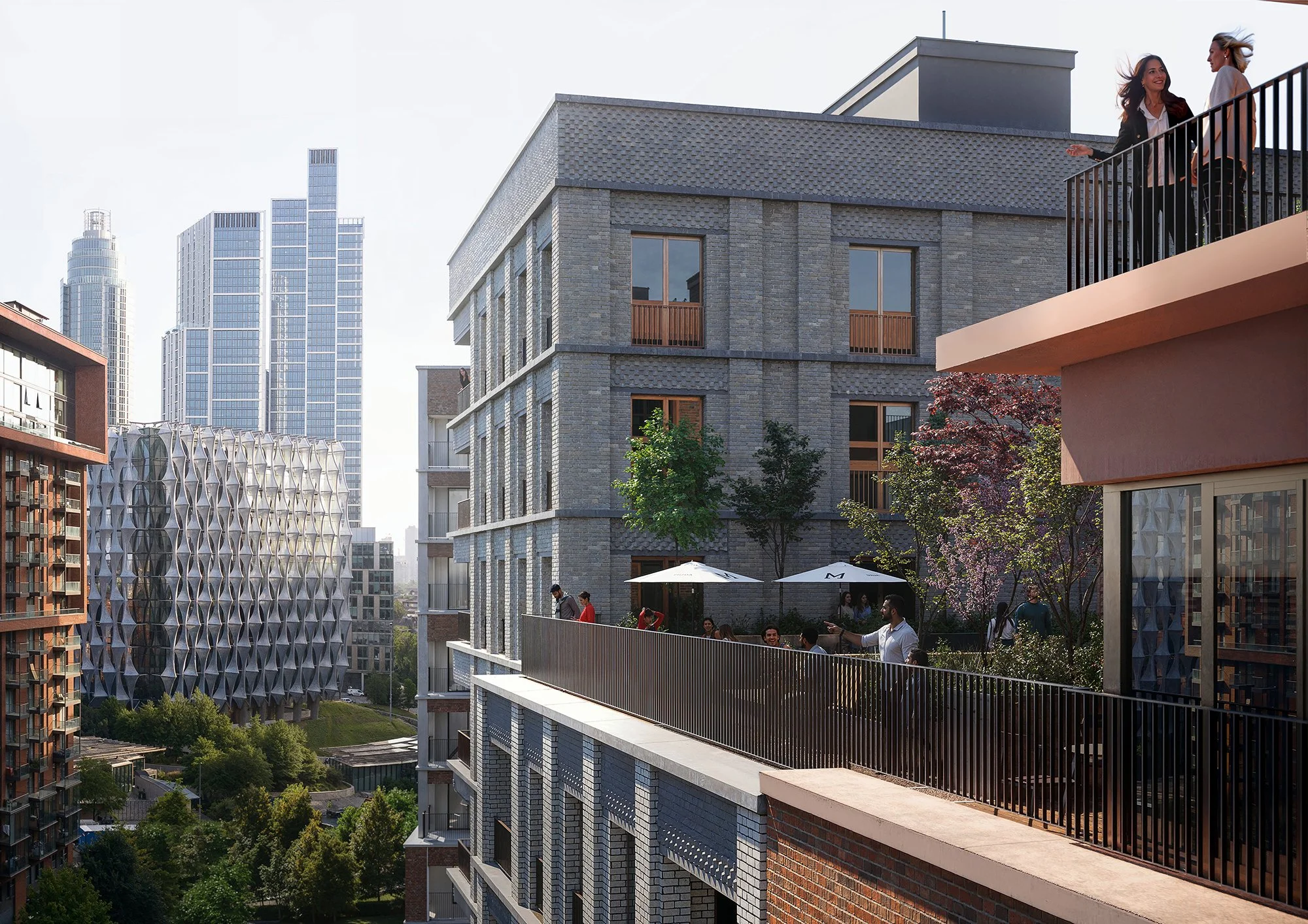 People gather on a rooftop terrace of a modern multi-story building with large windows, with city skyscrapers in the background and trees below.