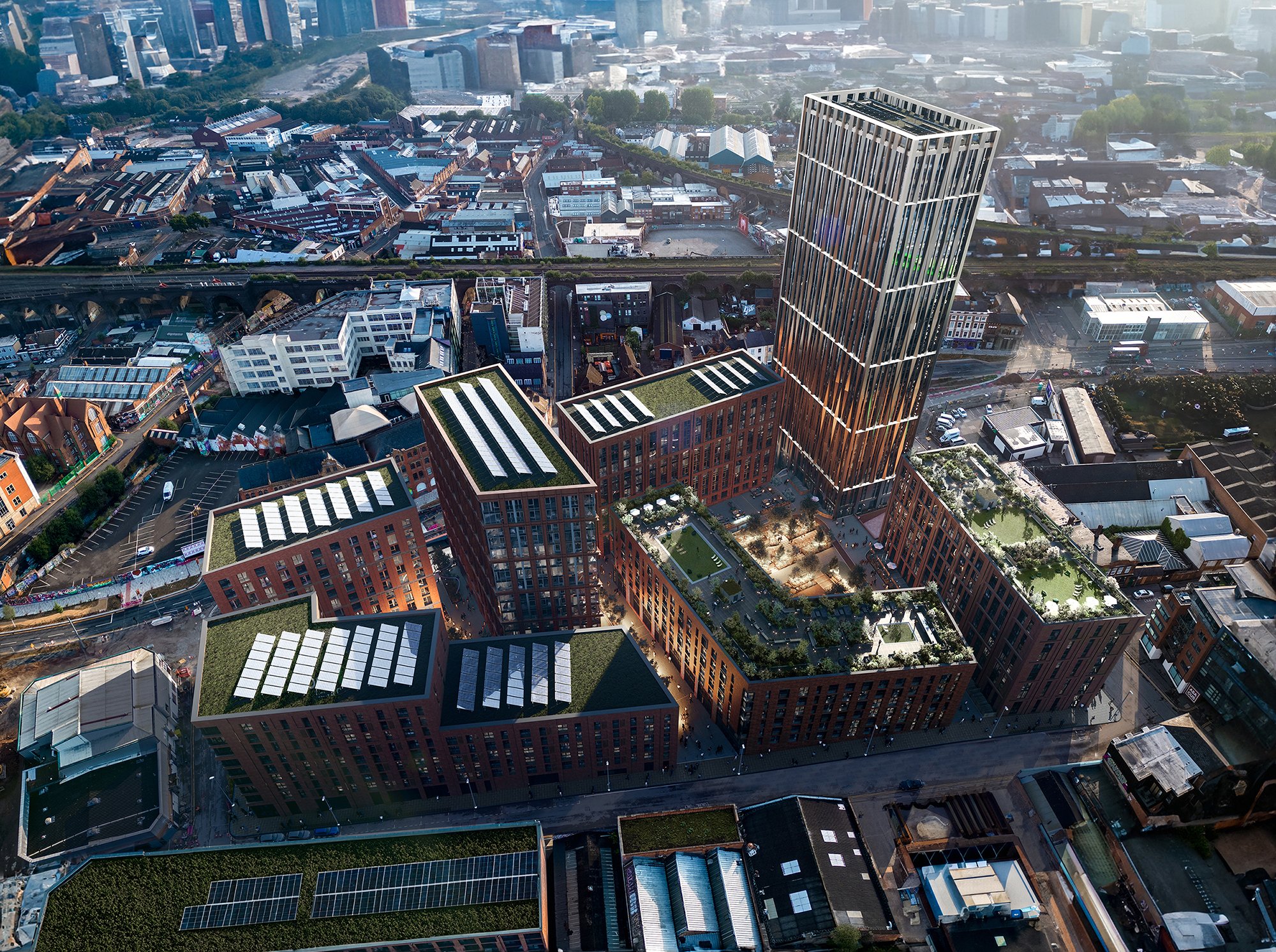 Aerial view of a city with tall buildings, residential areas, and green spaces, featuring a prominent modern skyscraper with a rooftop garden.