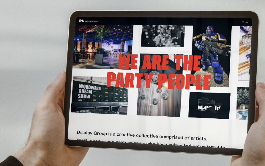Person holding a tablet displaying a collage of images, including a colorful interior, a black and white band photo, a robot figure, and text stating "WE ARE THE PARTY PEOPLE."