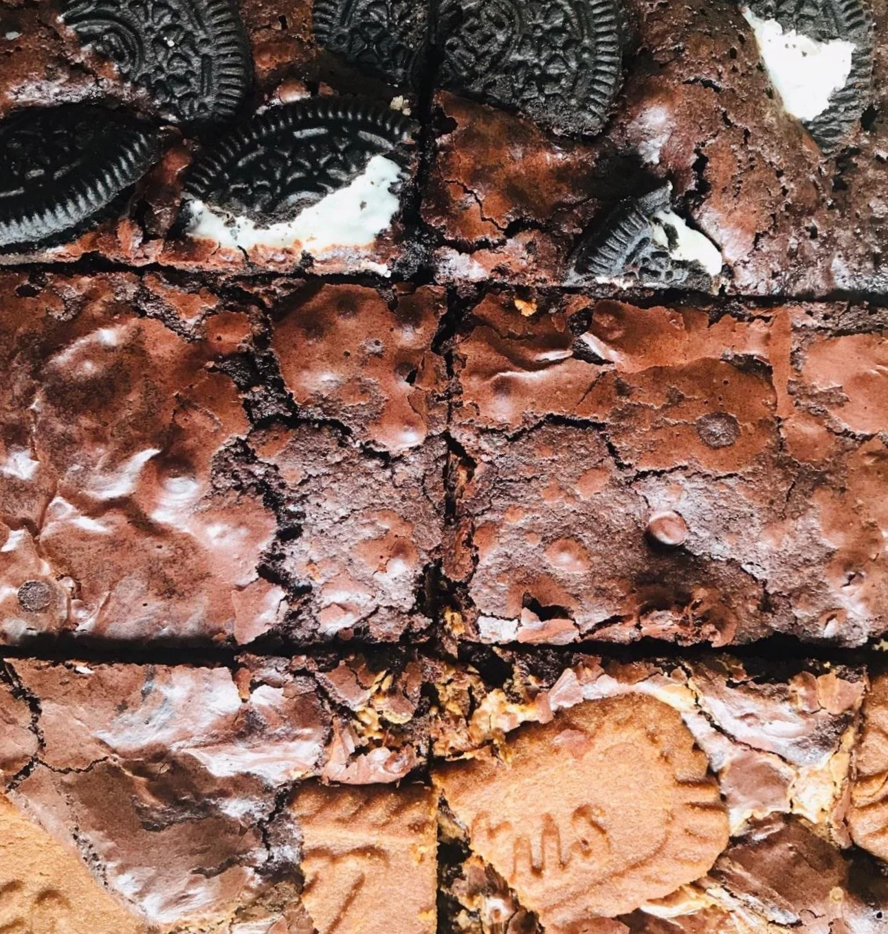 Close-up photo of stacked brownie bites with Oreo cookies and marshmallow cream