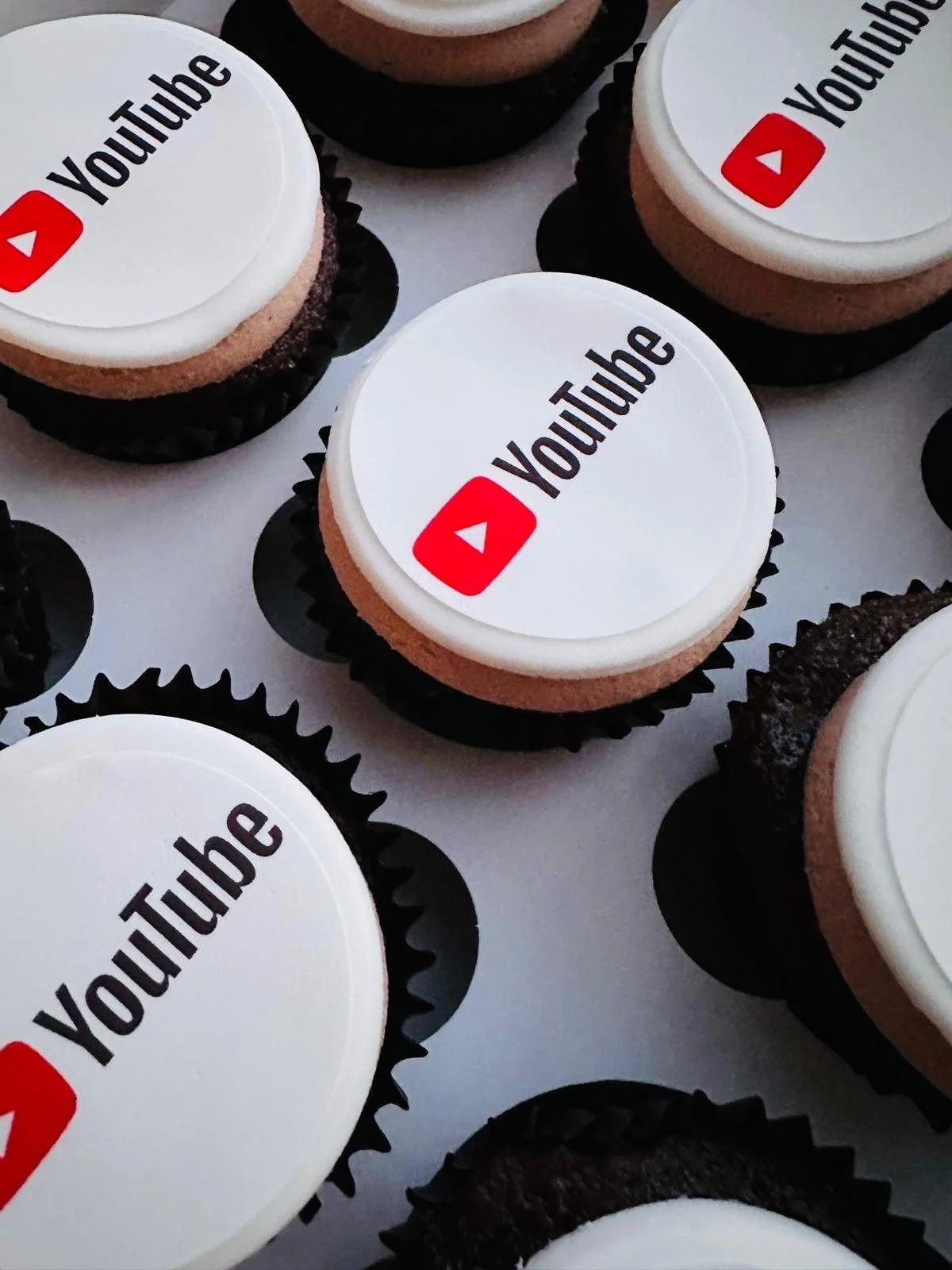 Cookies with white icing featuring the YouTube logo in red and black letters.