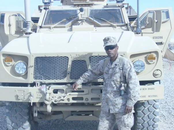 Roosevelt Dunn Jr. standing in front of an MRAP during combat operations in Afghanistan.