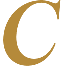 Close-up of a large, gold-colored letter 'C' on a plain background.