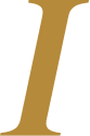 Close-up of a gold letter 'I' on a black background.
