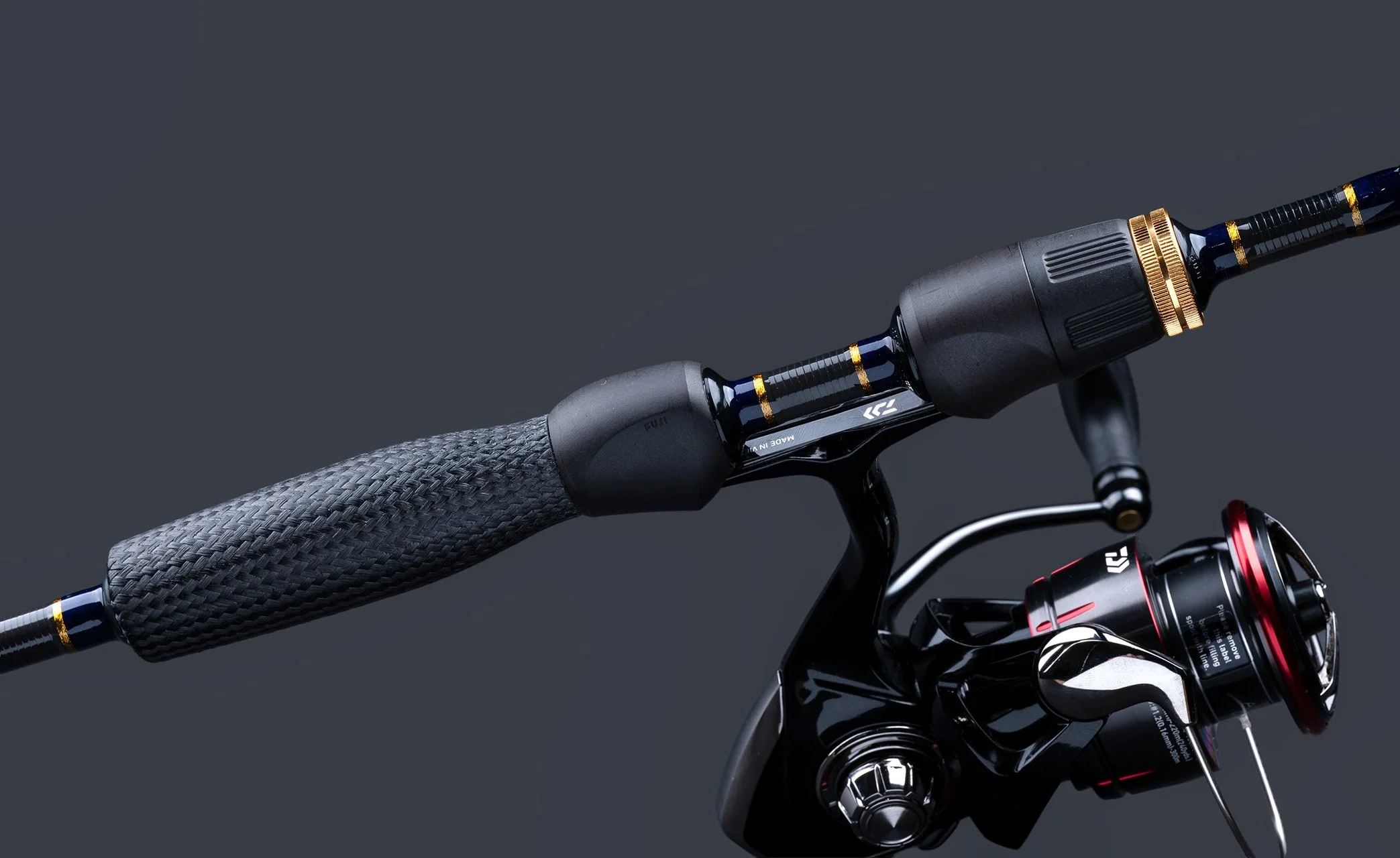 Close-up of a modern bicycle handlebar, featuring a textured grip, a gear shifter, and a brake lever against a dark background.