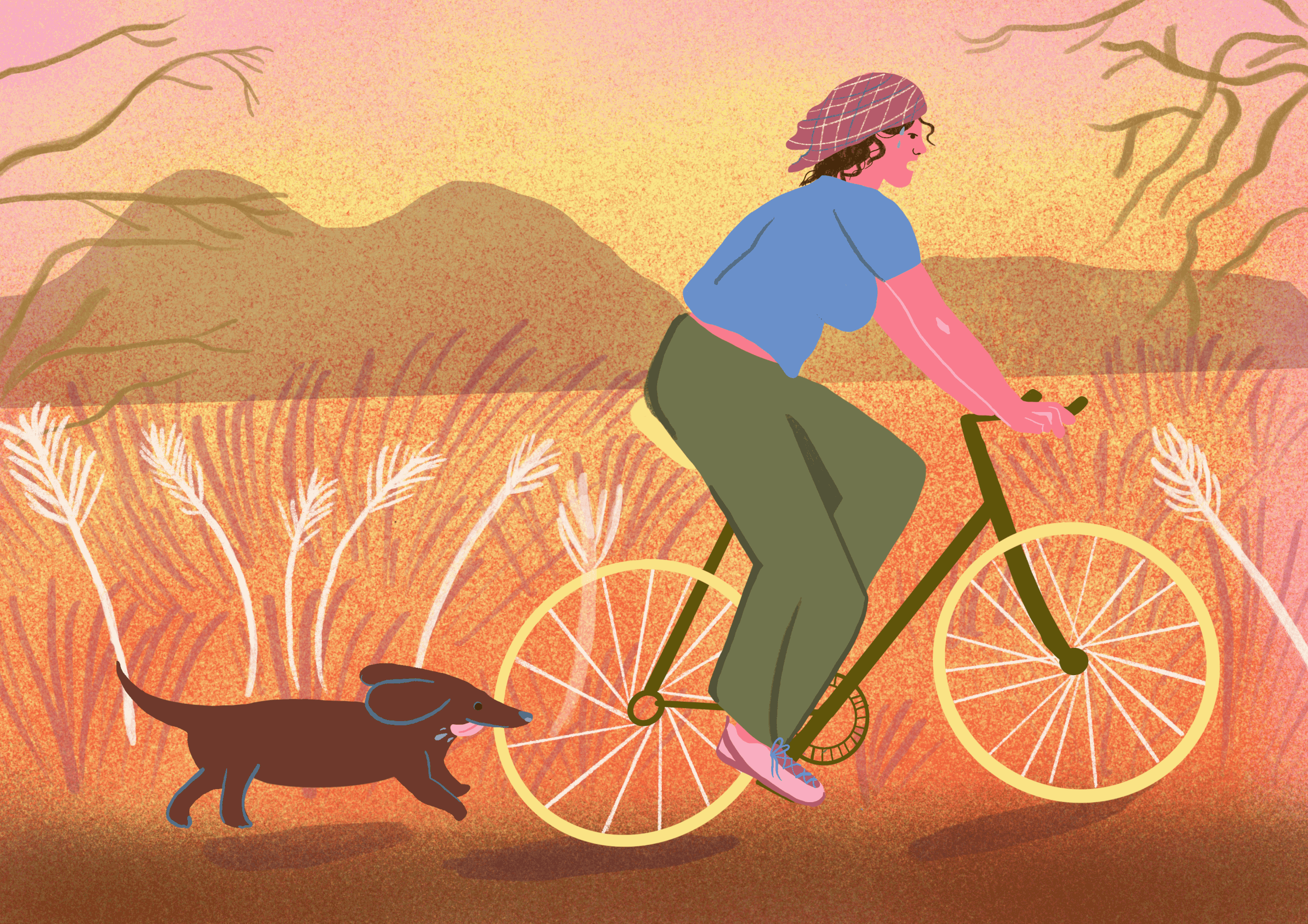 A woman wearing a checkered headscarf, a blue t-shirt, and green pants riding a yellow bicycle in a field of tall grass, with a brown dog walking beside her, and mountains in the background during sunset.