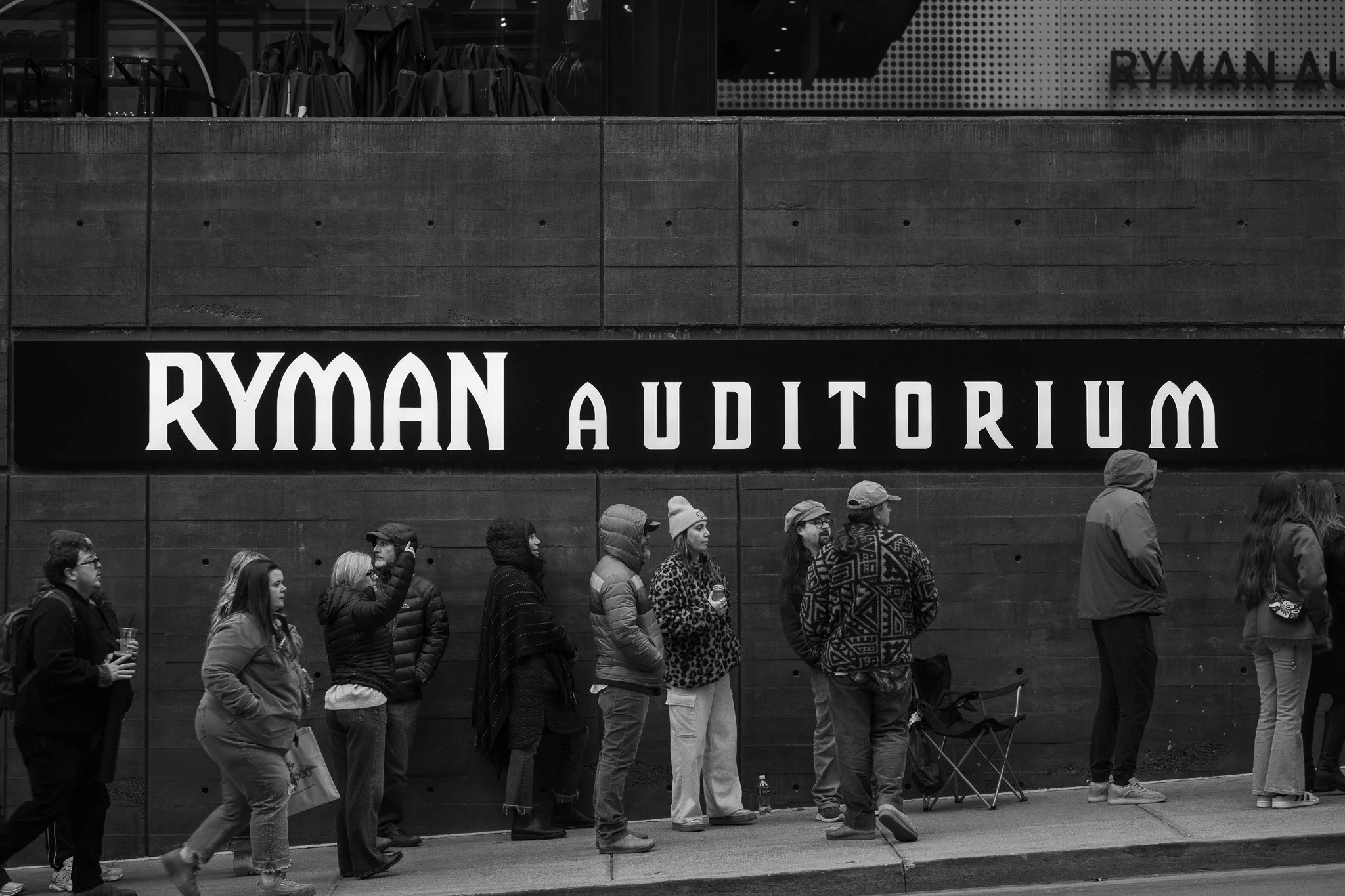People standing in line outside the Ryman Auditorium.
