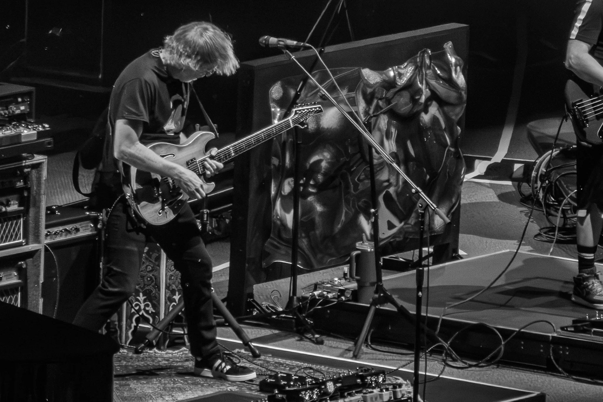 Black and white photo of Trey Anastasio playing at Madison Square Garden on 7/25/26. A part of the Phish in Five series.