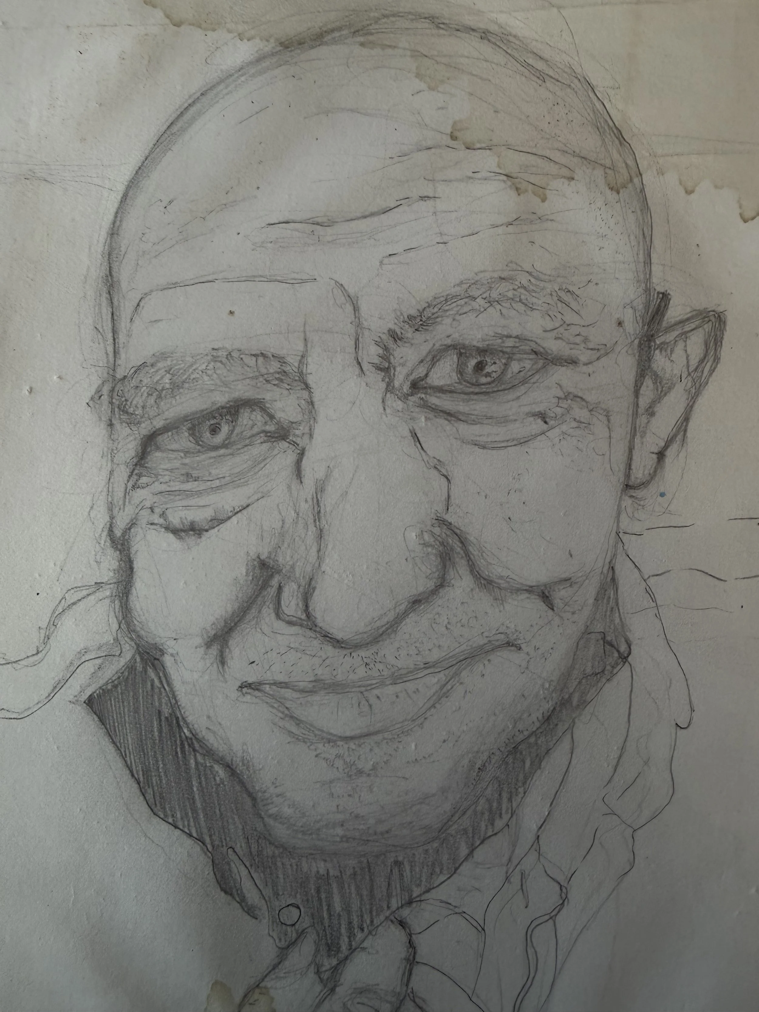 A sketch of an elderly person with glasses, deep facial lines, and a serious expression, on a slightly stained piece of paper.