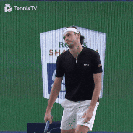 A male tennis player on a court, holding a racket, with a Green backdrop and the logo 'Tennis TV' in the top left corner.