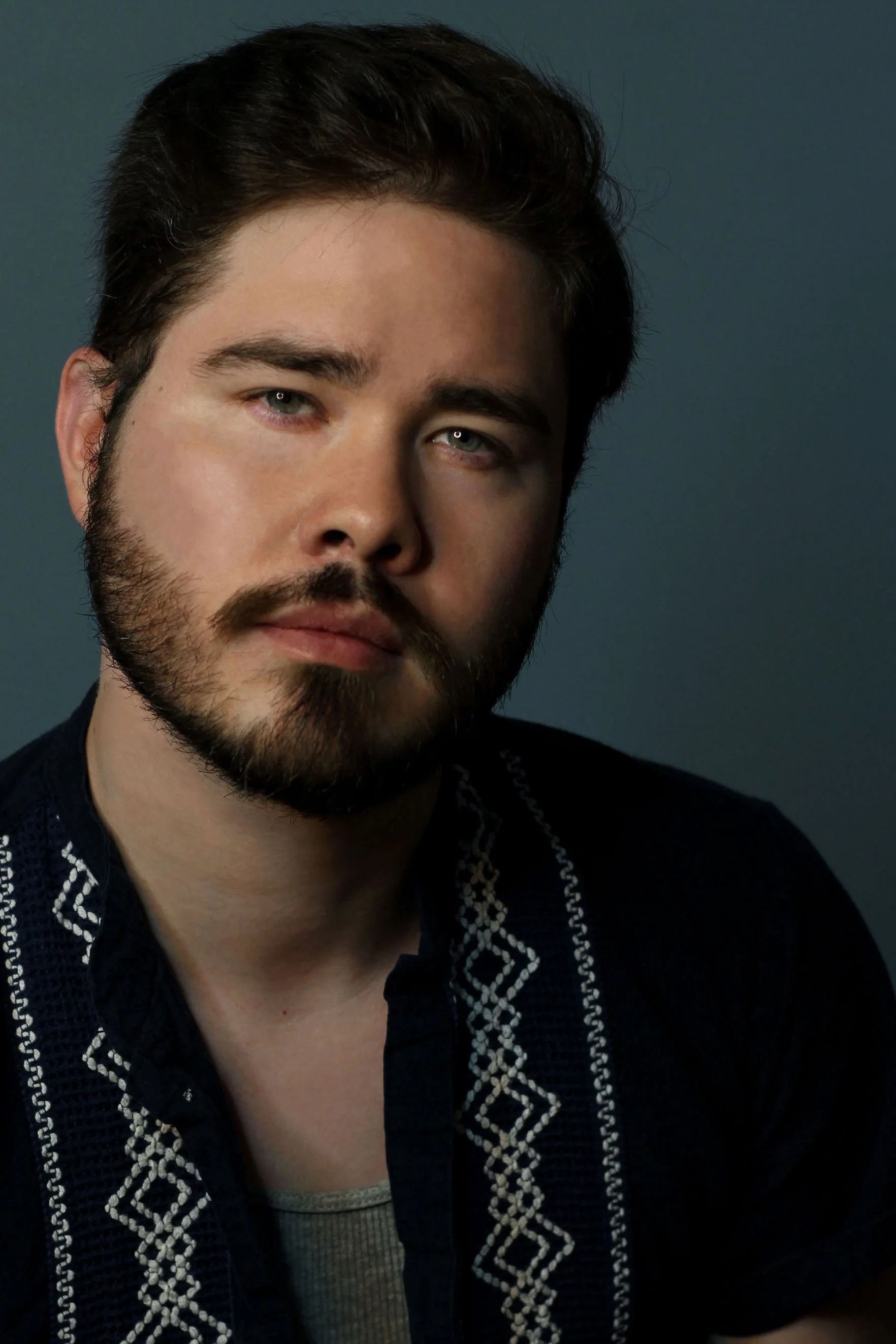 kelanblueshirtbluebgcroppped.jpg