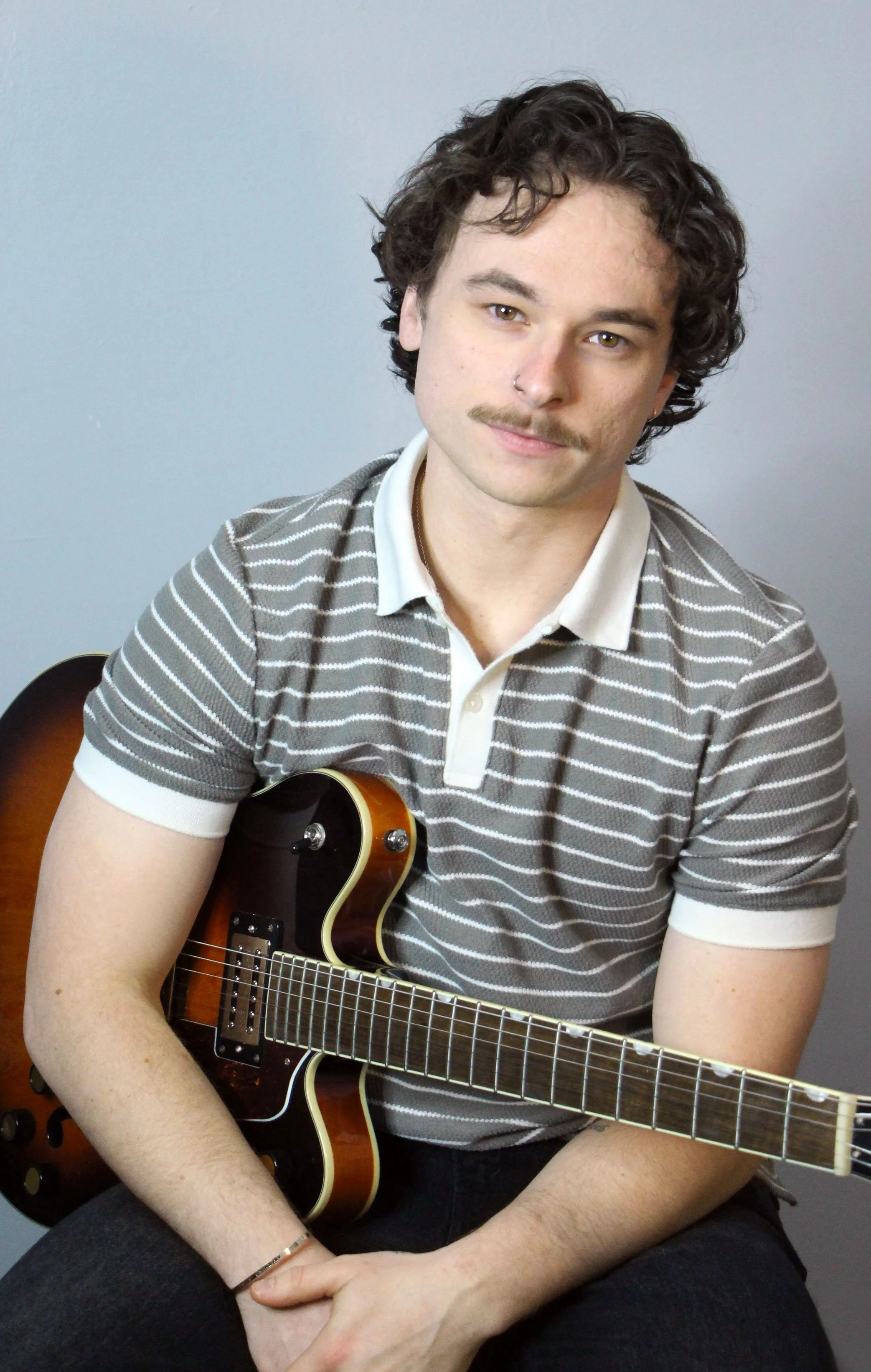 zacactualfinalheadshotguitar.jpg