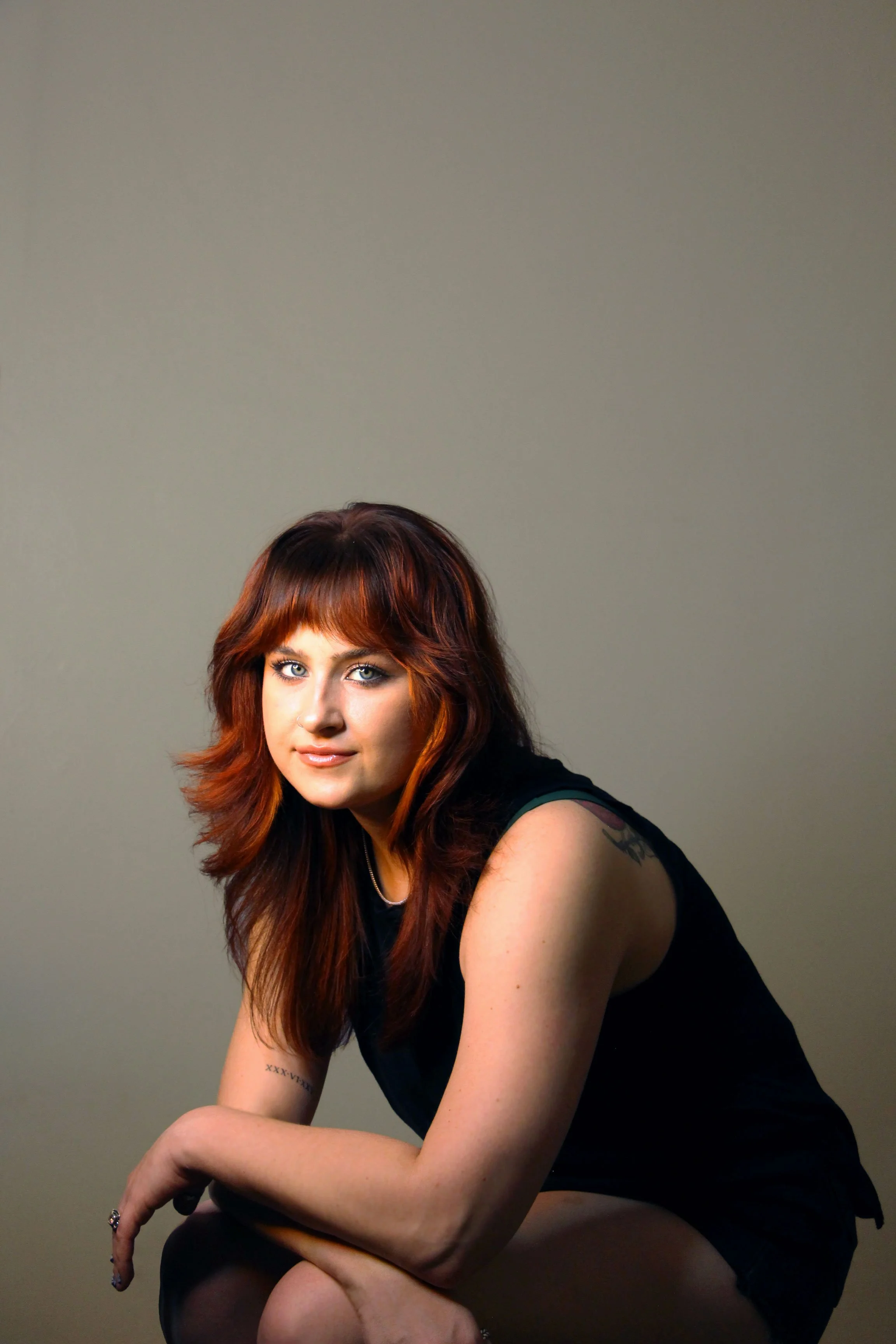 4-sitting-black-top-neutral-bg.jpg