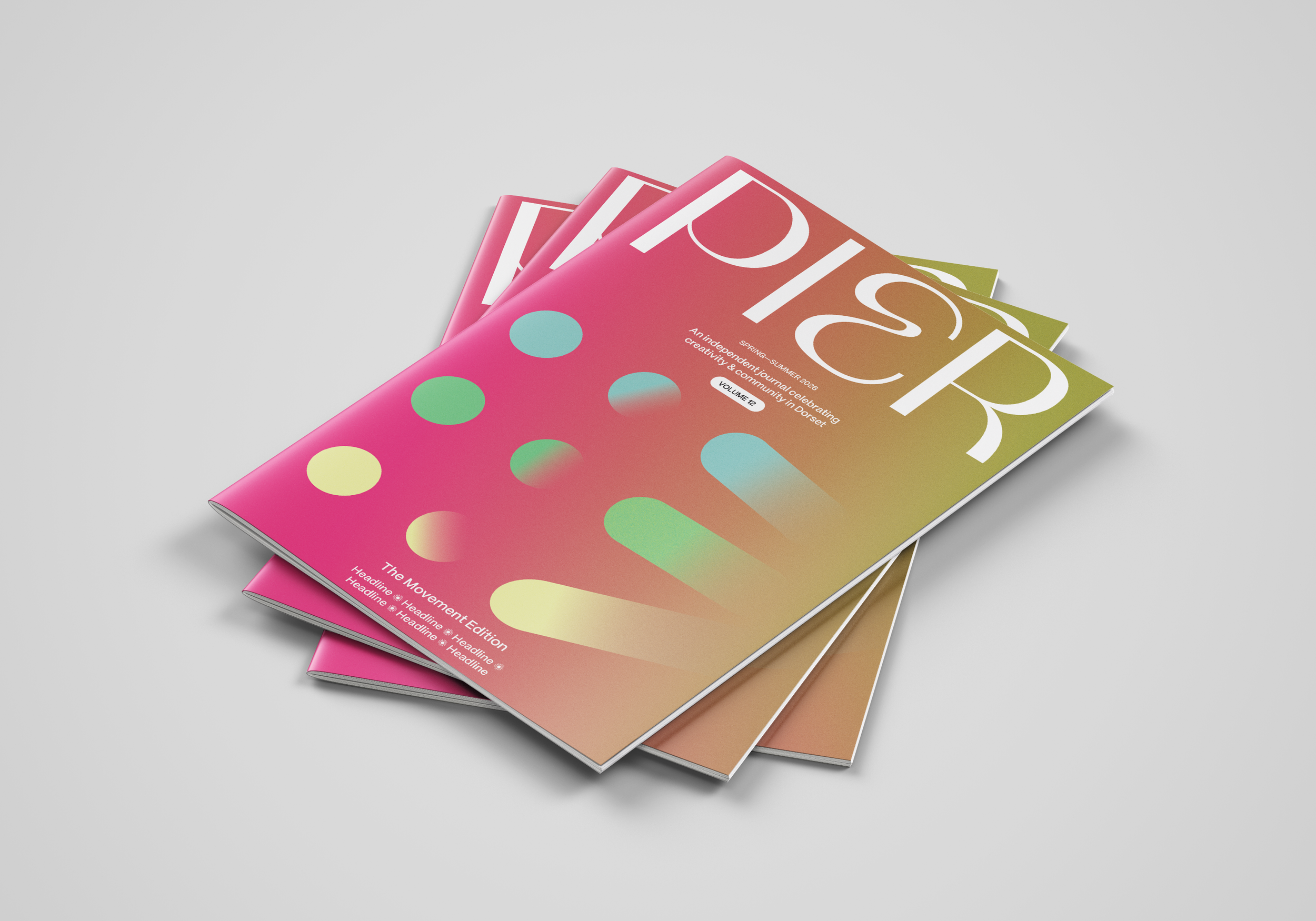 A stack of colorful magazines with a gradient background and abstract dot patterns on the cover.